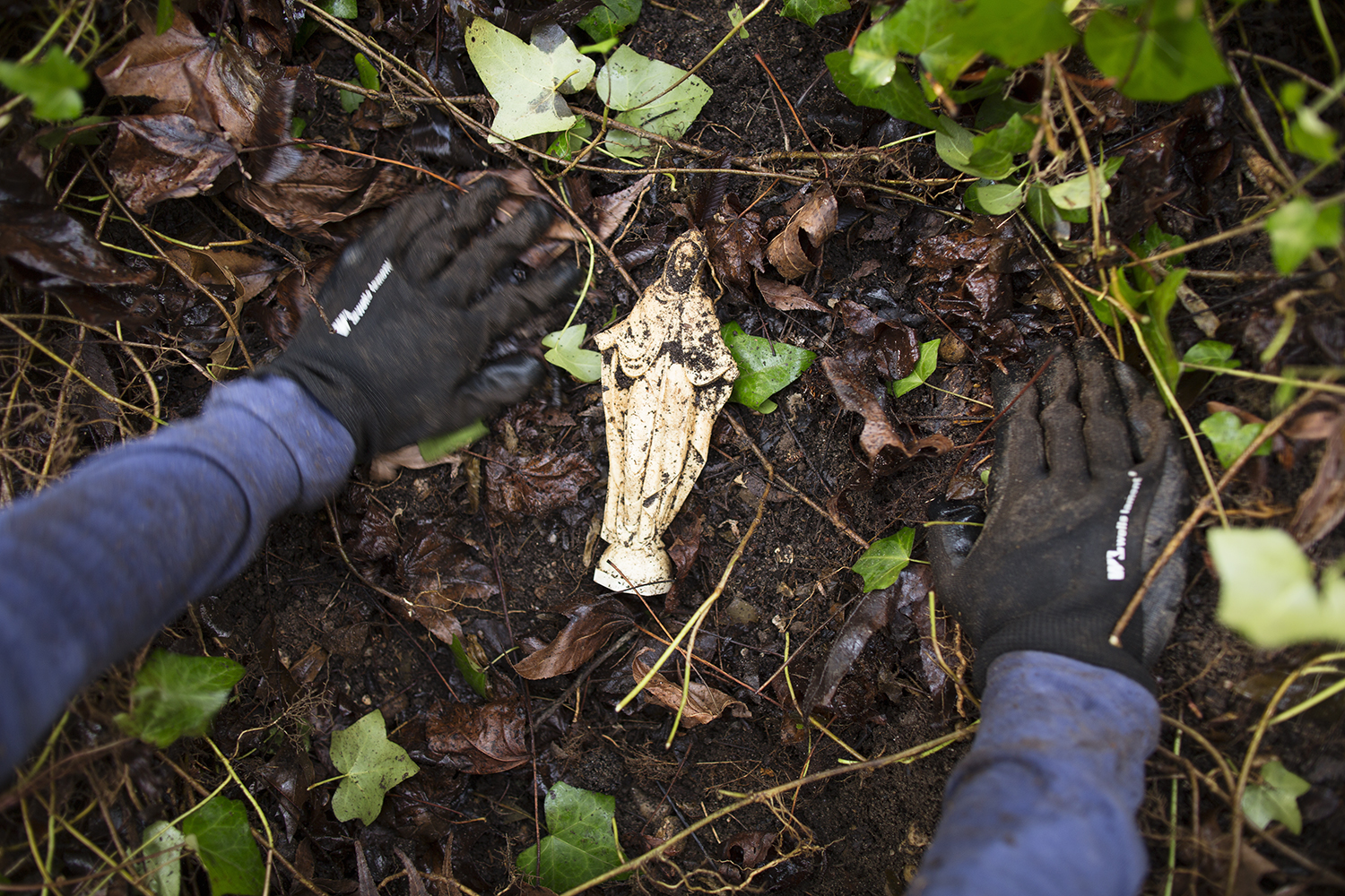 Erin clears brush from an item found near June Anderson's grave marker, East End Cemetery work day, January 2015. ©brianpalmer.photos 2015