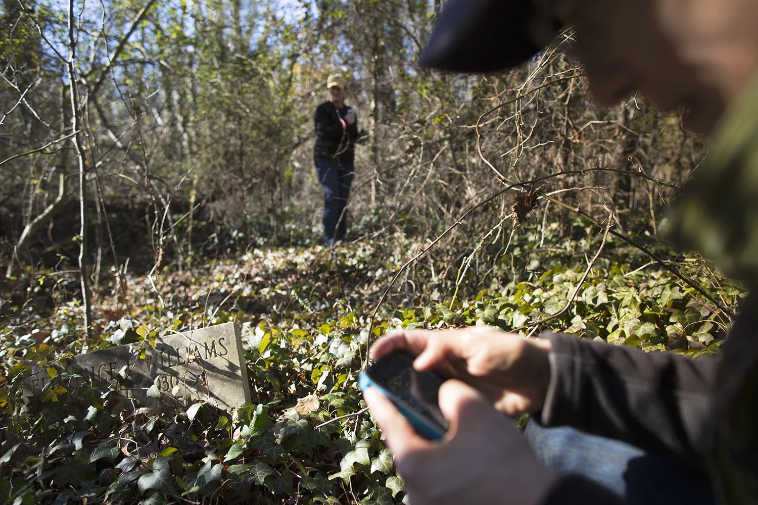 Erin texts information on discovery to historian friend Vicki, East End Cemetery, Henrico County/Richmond, Virginia, January 31, 2015. ©brianpalmer.photos 2015