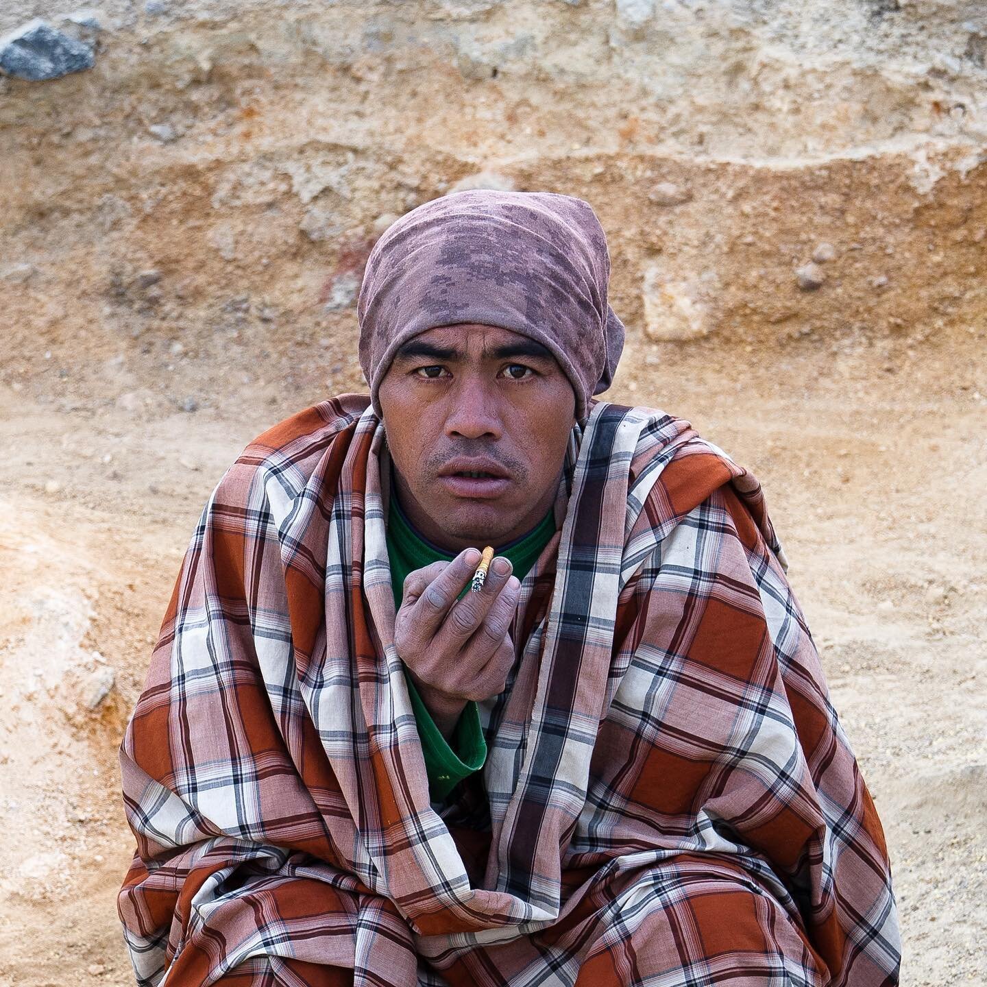 This is a local Indonesian sulfur miner. He gets paid based on the weight of sulfur he can carry, from deep inside the volcano crater approx half a mile up the rocky landscape. All the while burning his lungs from the sulfur gas and tears streaming d