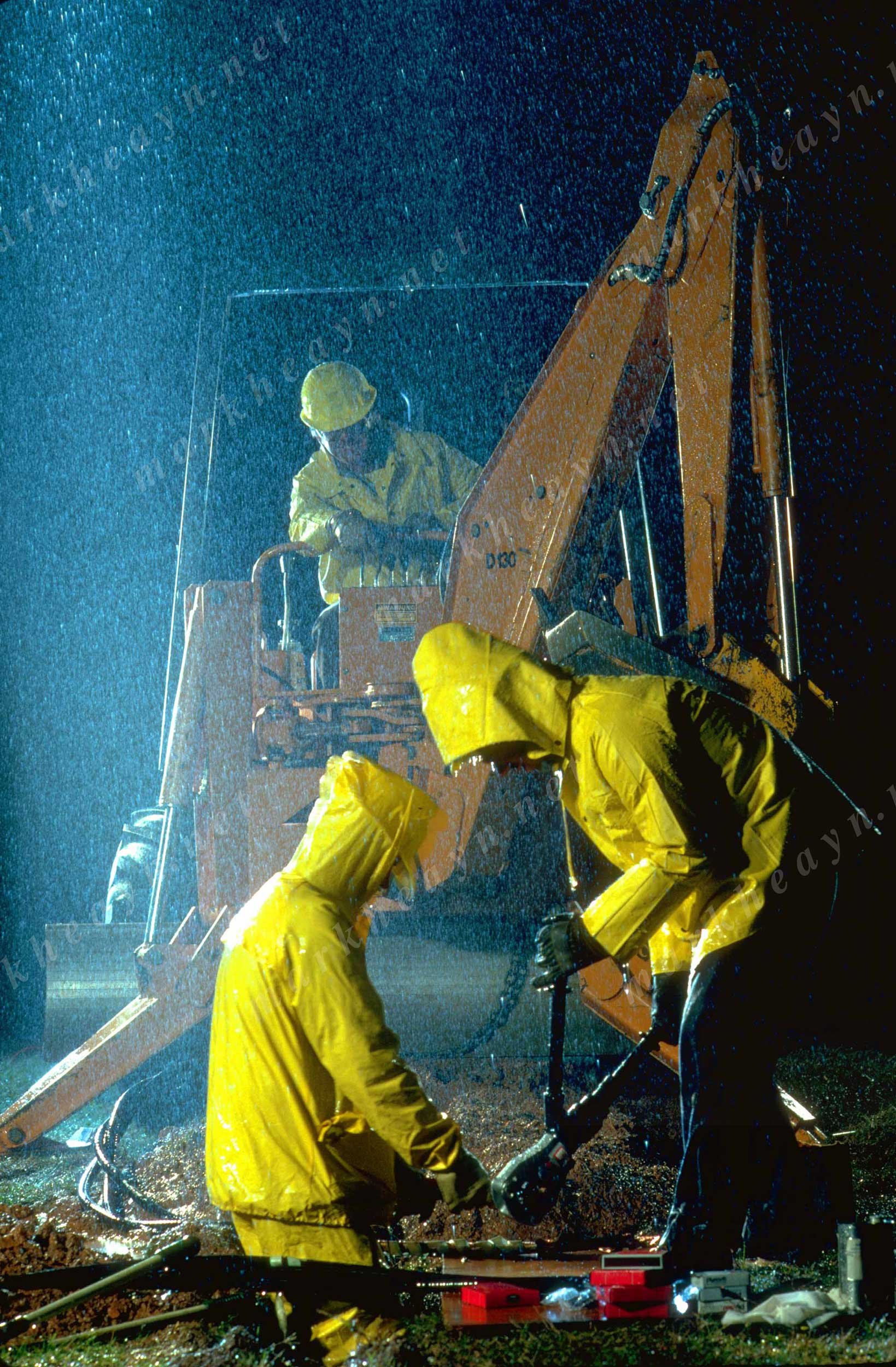 two elecricians working in the rain.jpg