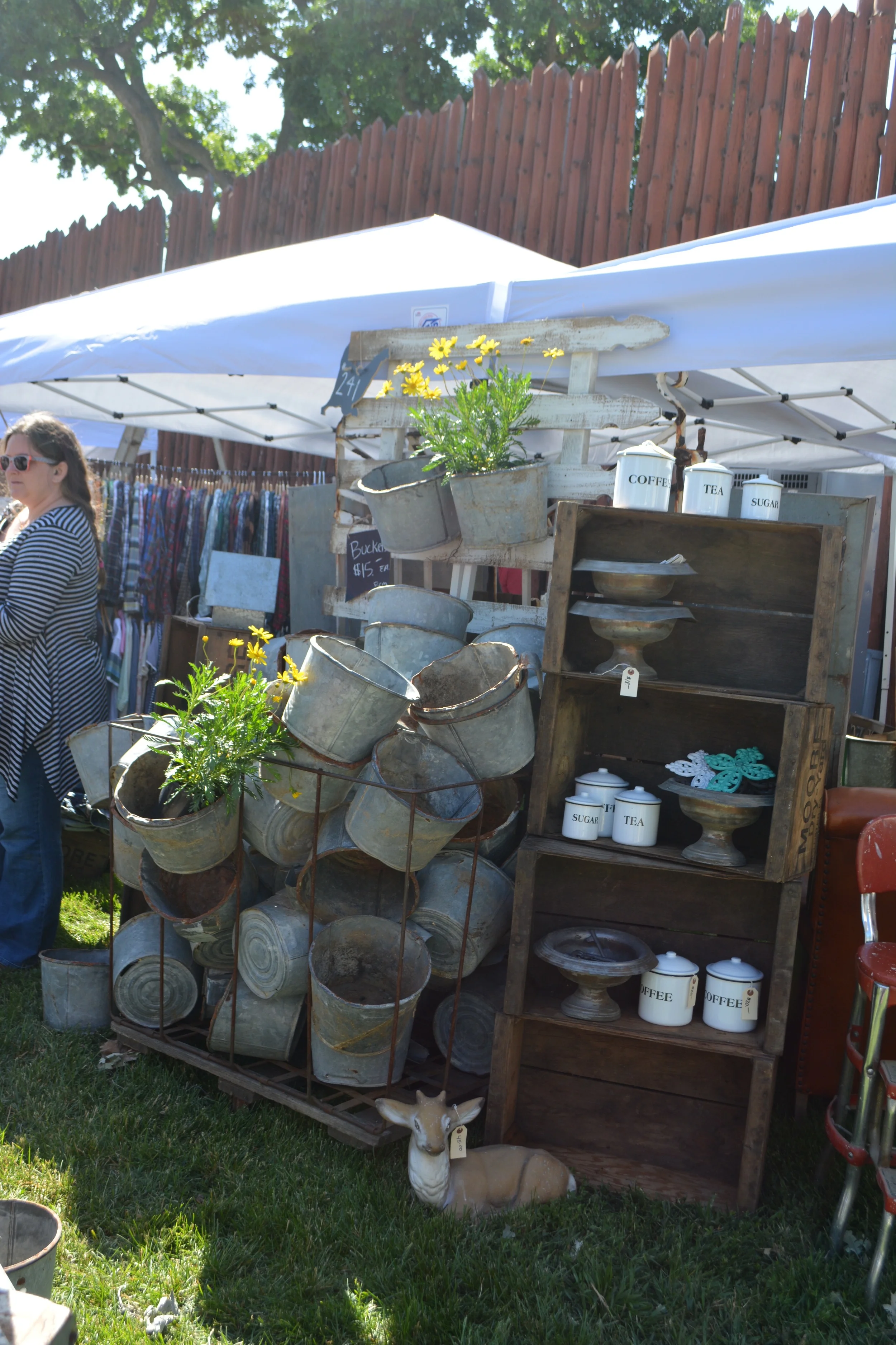 Stacks of galvanized buckets and large wooden cupboard