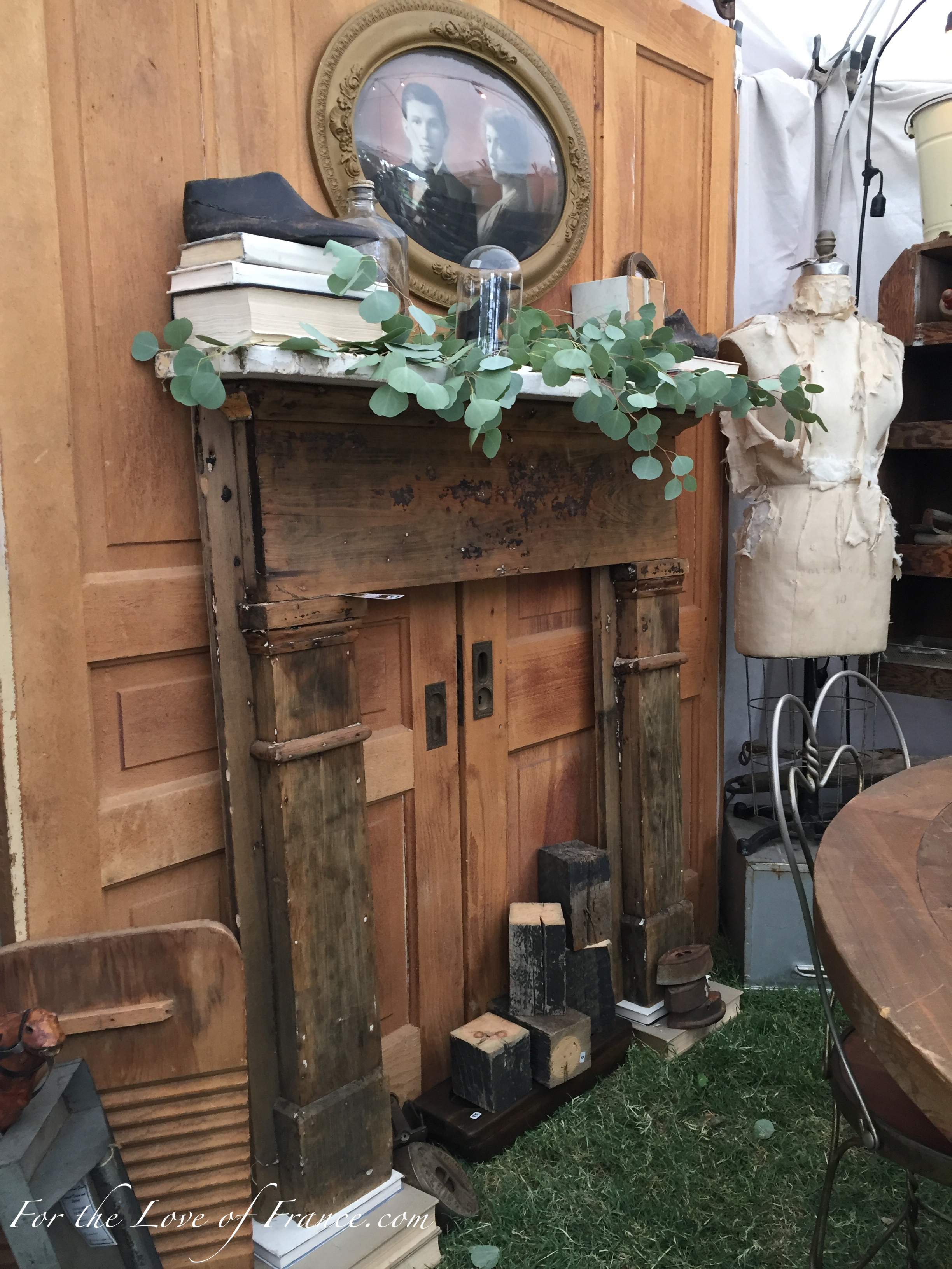 Vintage display with wooden pocket doors and fireplace surround