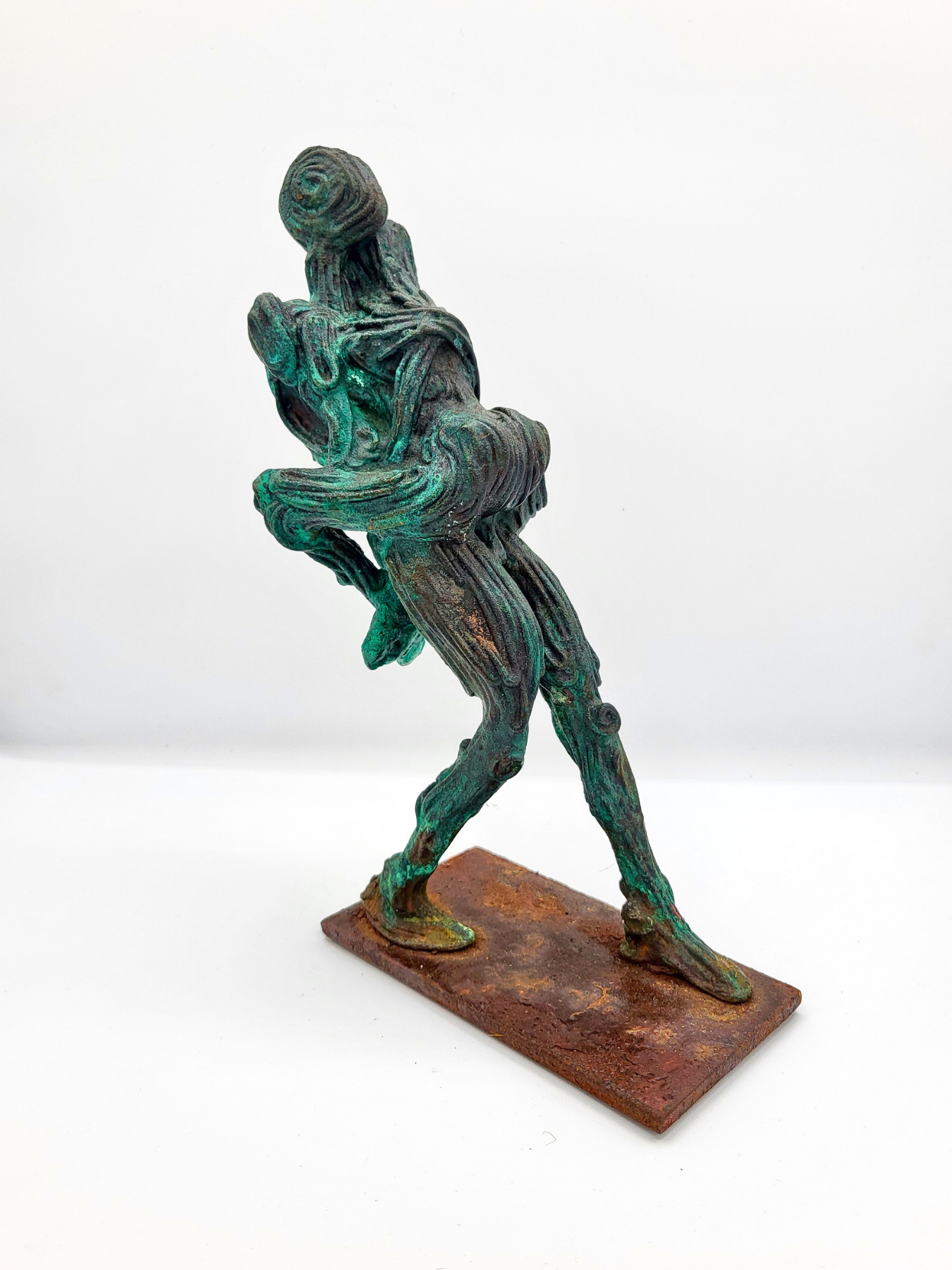 A sculpture of two dancers, one holding the other in his arms as he leans backward. Made by artist J. Aaron Alderman from steel round stock and finished with a copper patina.