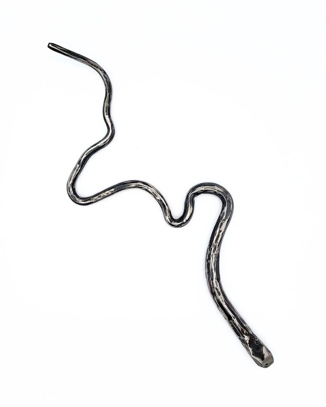 Hand-forged steel snake on a white background.