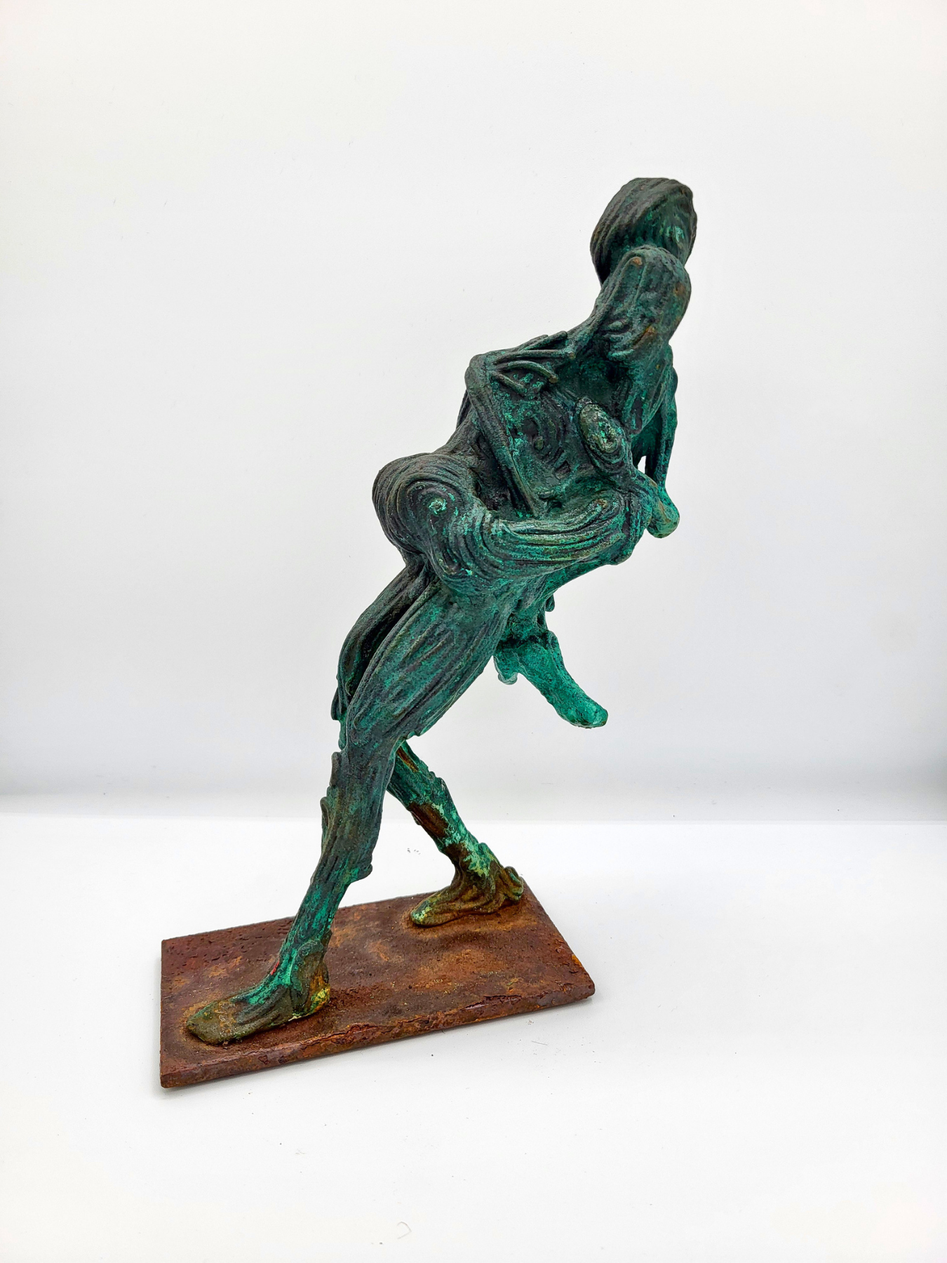 A sculpture of two dancers, one holding the other in his arms as he leans backward. Made by artist J. Aaron Alderman from steel round stock and finished with a copper patina.