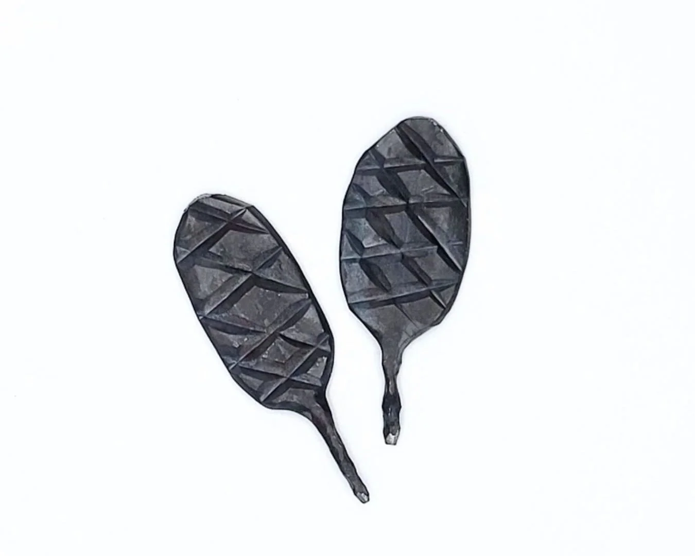 Two steel divot tools for golf on a white background.