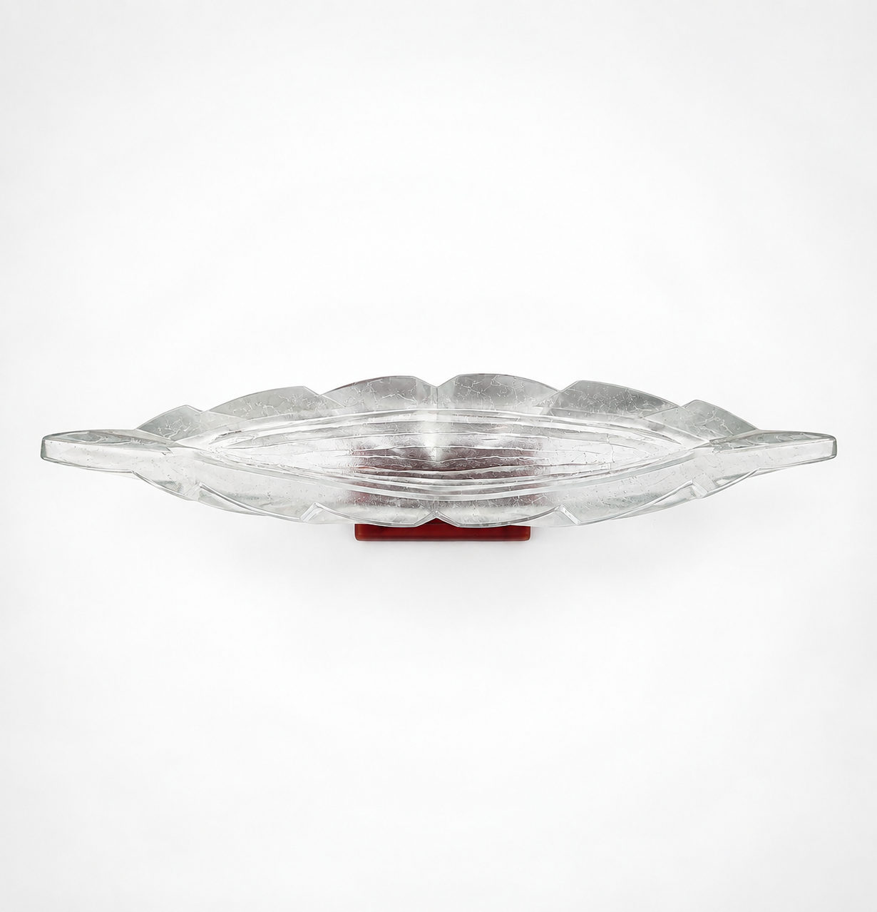 Clear cast glass sculpture with a red glass base against a gradient white background by artist Rick Beck.