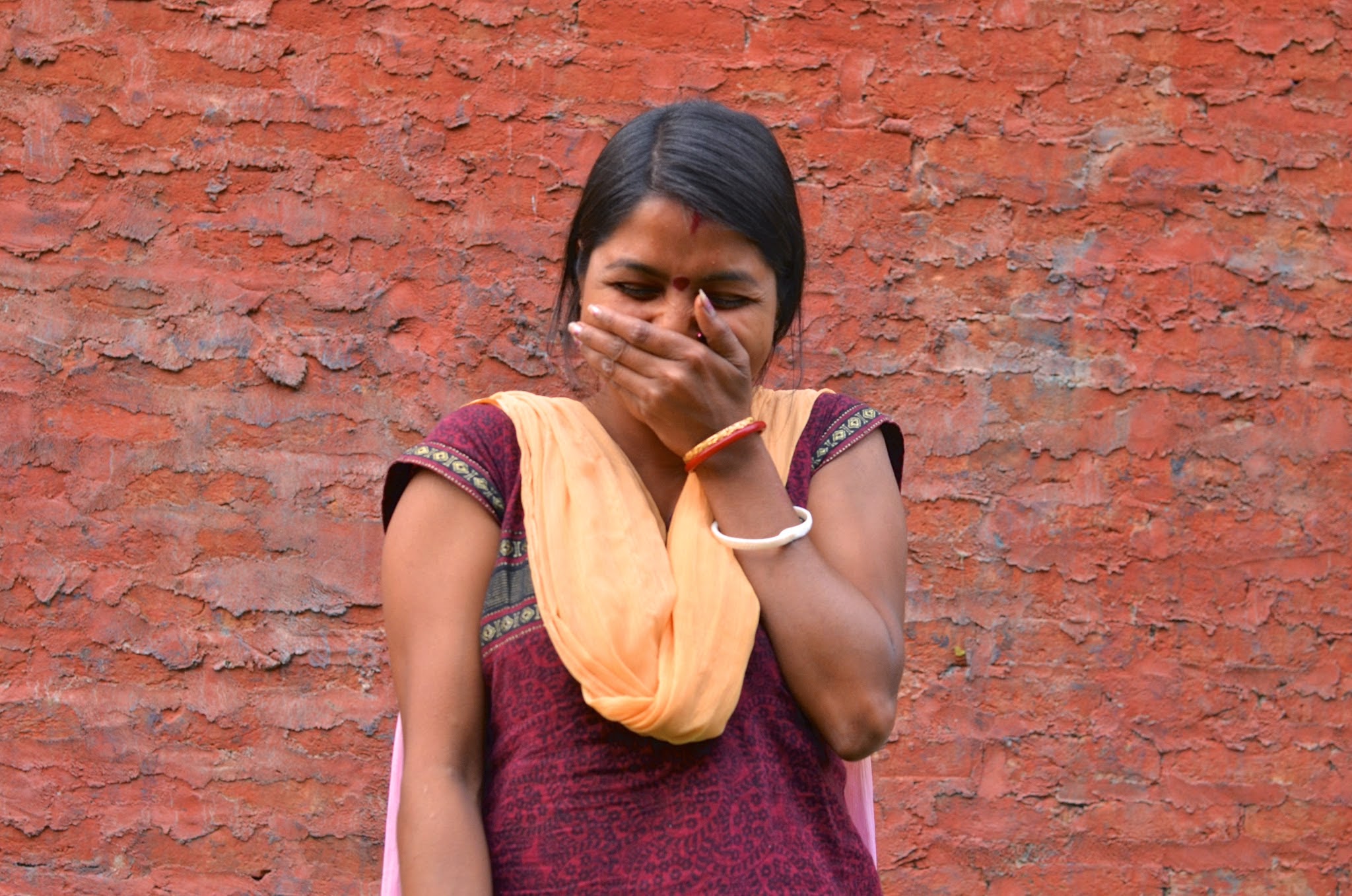 Rekha giggles as her co-workers coax her into singing for the members of the Upaya team (not pictured)
