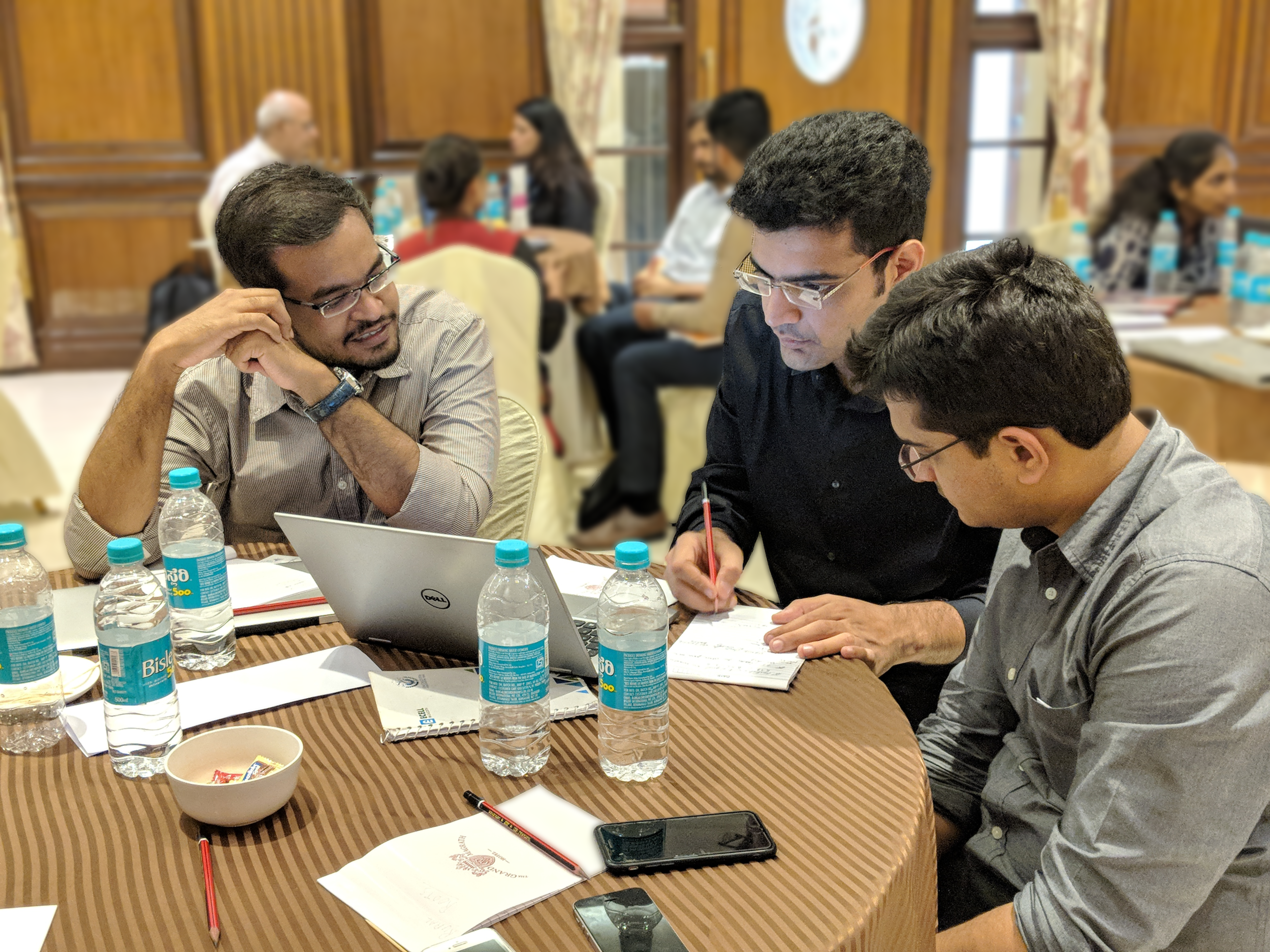 Kunal Bhatia (center) and Shagun Setia (left), work through their financial plan with their mentor, Shreyansh from Ankur Capital.