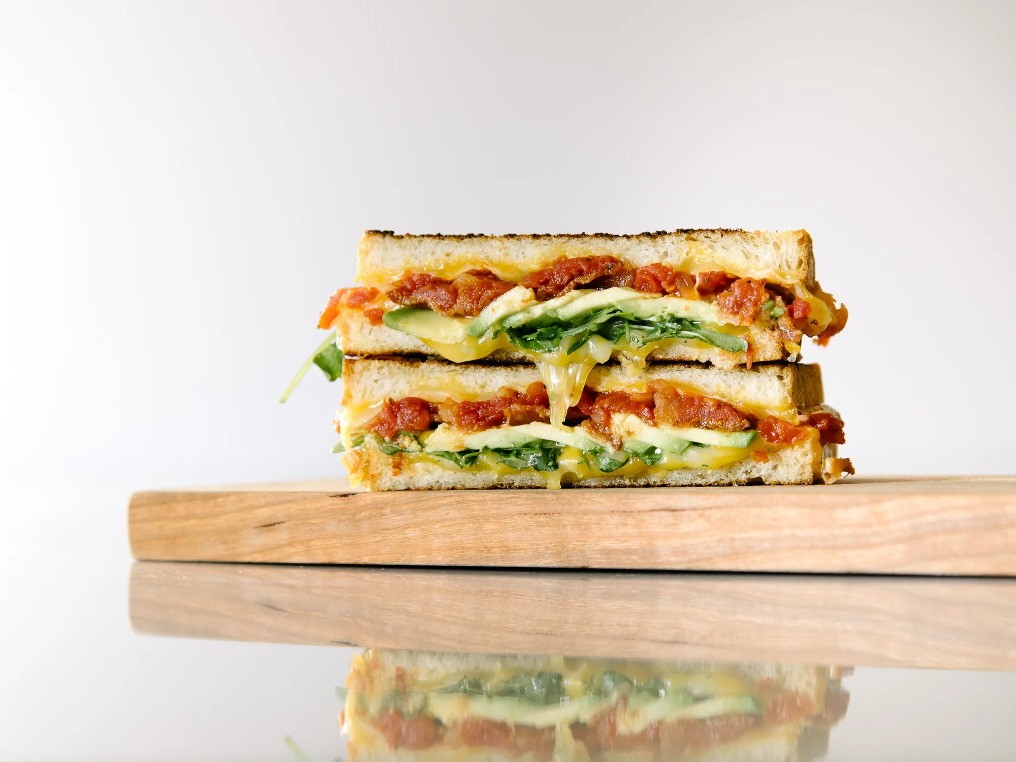 Grilled Cheese w/Spicy Tomato-Onion Jam, Arugula, Avocado, Bacon, & Colby Jack