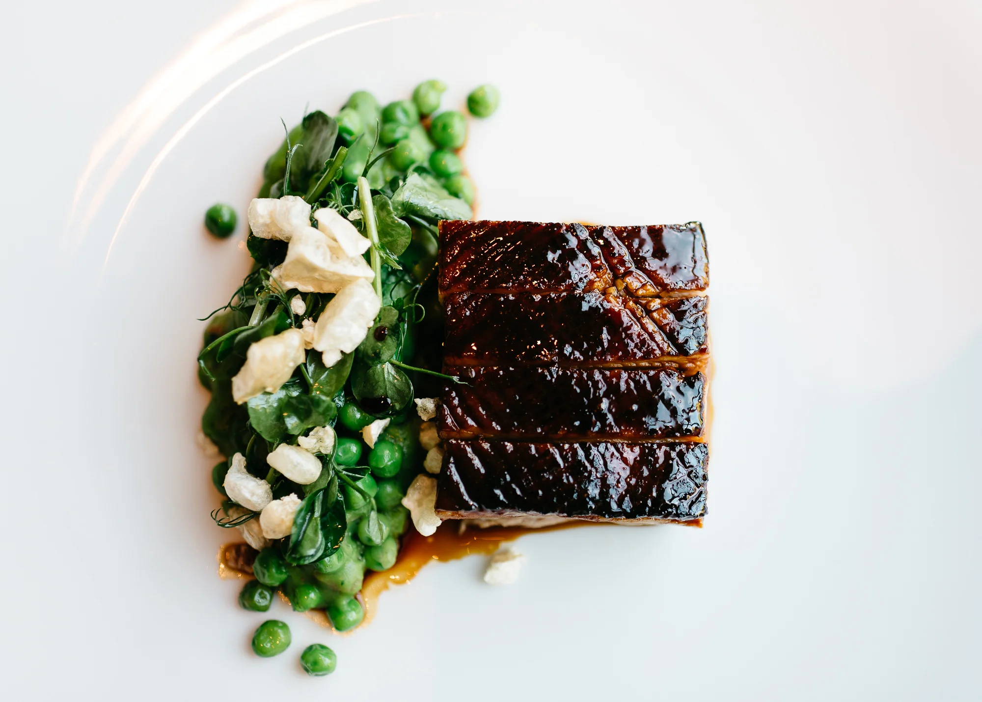 Slow cooked pork belly at Dinner by Heston Blumenthal with spelt, lardo, baby turnip & Robert sauce