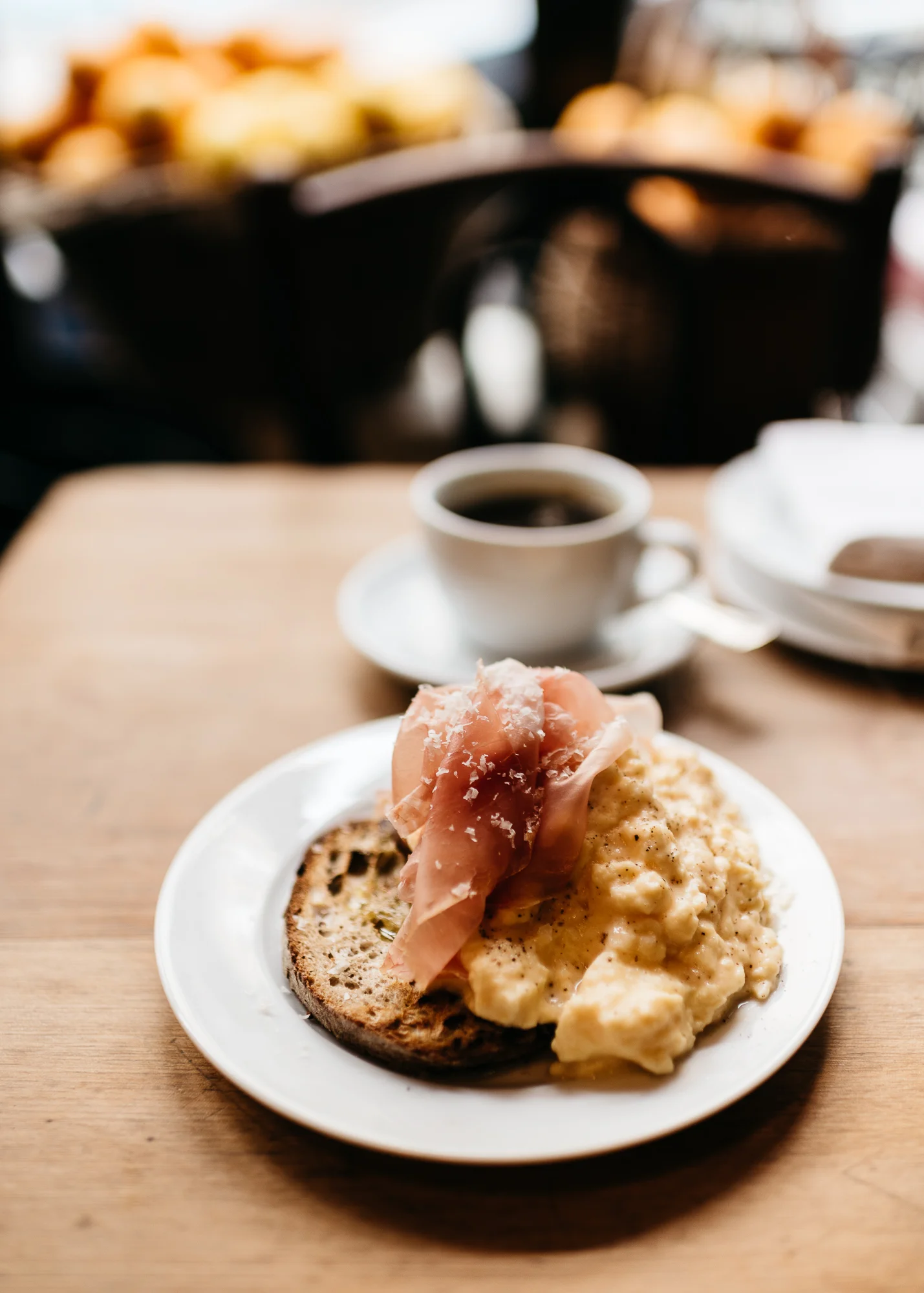 Steam scrambled eggs and prosciutto on grilled bread at Buvette Paris