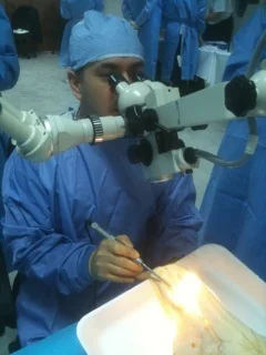 Bolivian neurosurgeon Dr. Carlos Dabdoub perfects drilling techniques using a microscope.