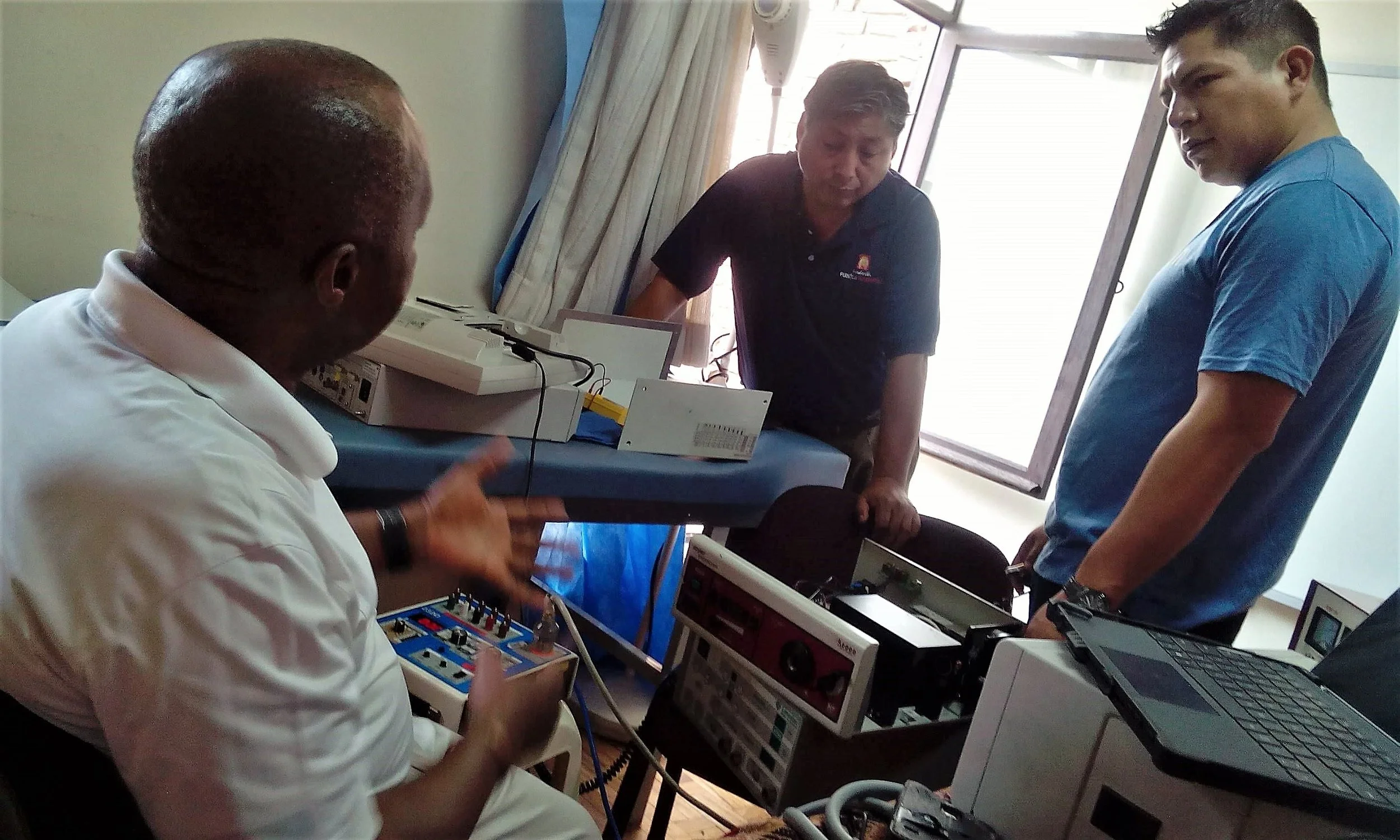 José Choque (center) consults with the mission team.
