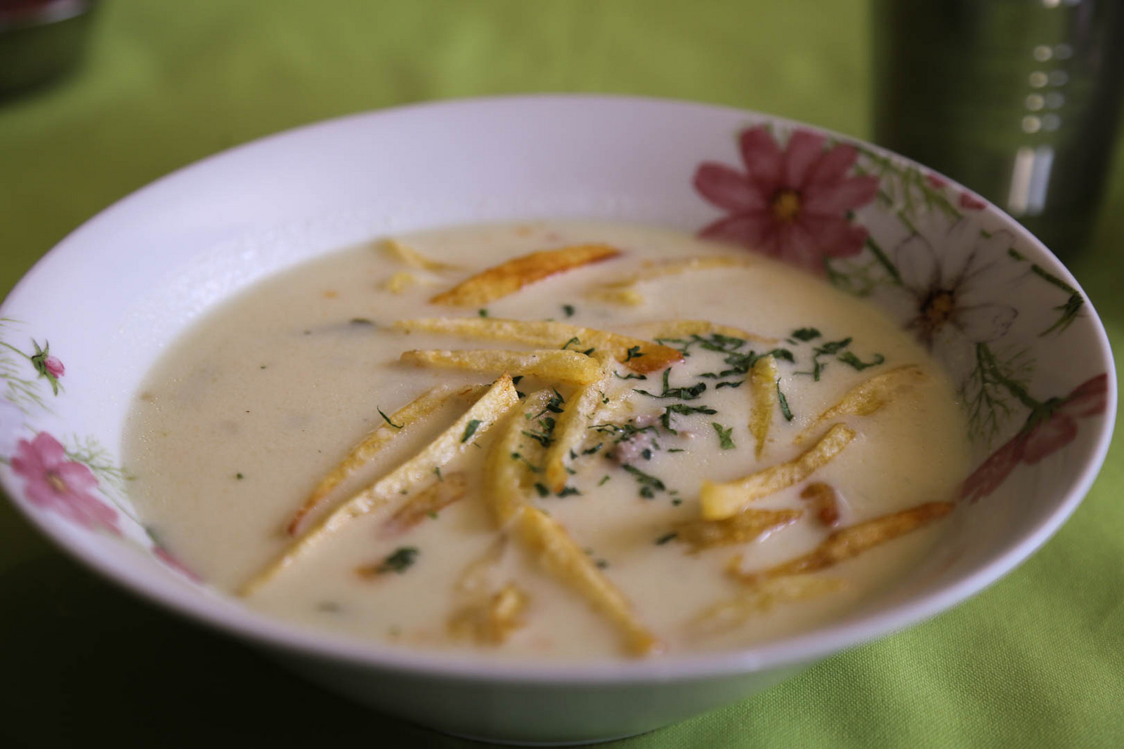   Sopa de maní  (peanut soup), a nourishing broth made from ground peanuts, has a garnish of fried matchstick potatoes. 