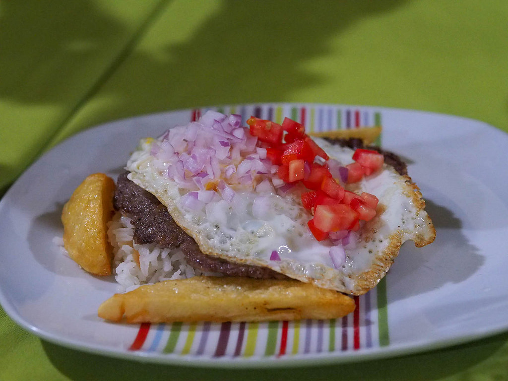  With a name from the Quechua language,  silpancho  is a traditional dish featuring rice, breaded meat, and a fried egg. 