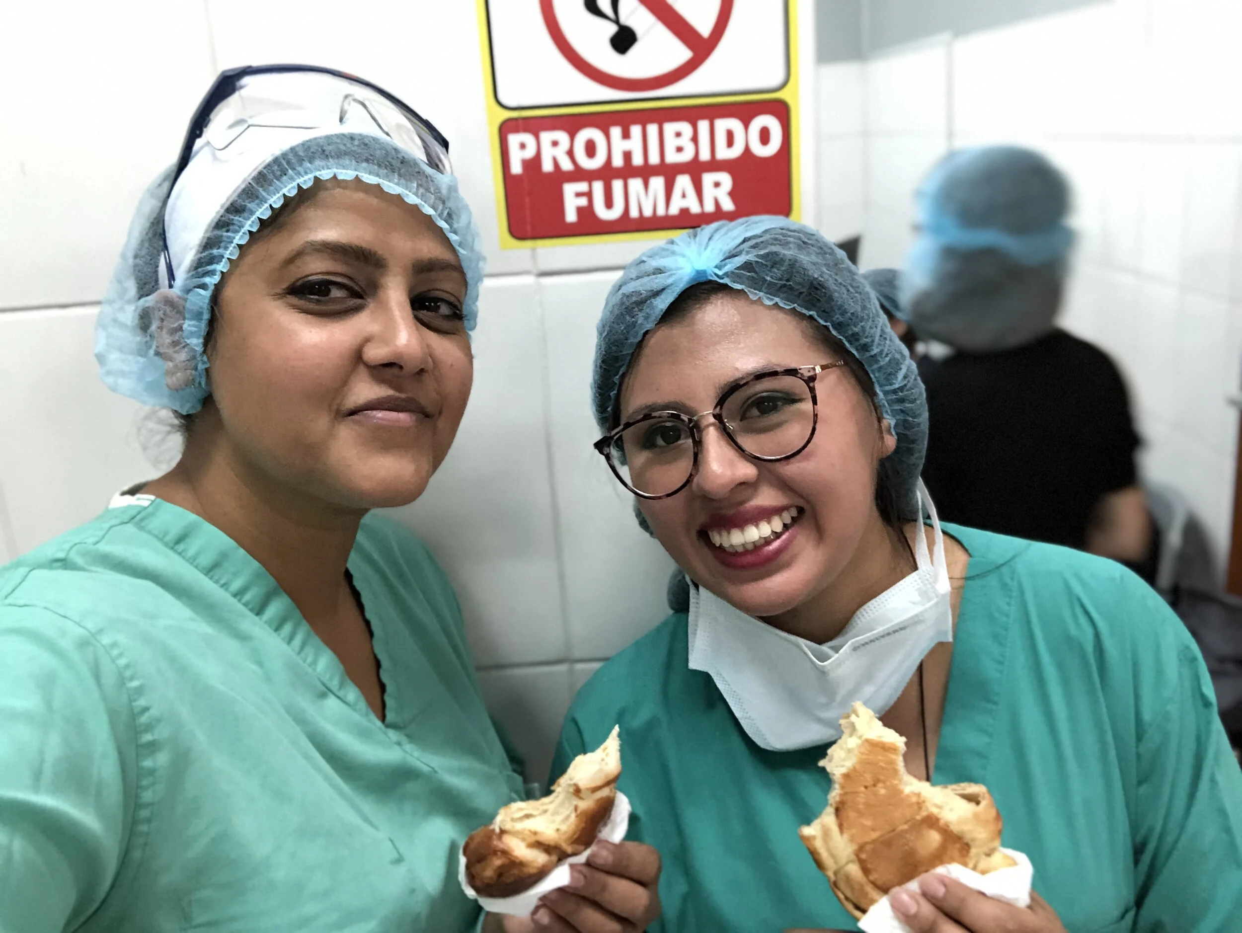 Dr. Shelly and her interpreter Dr. Denise take a quick snack break, enjoying a Bolivian salteña.