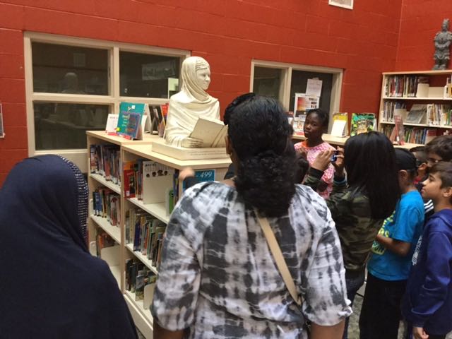Students interacting with Malala sculpture at Lougheed Middle School