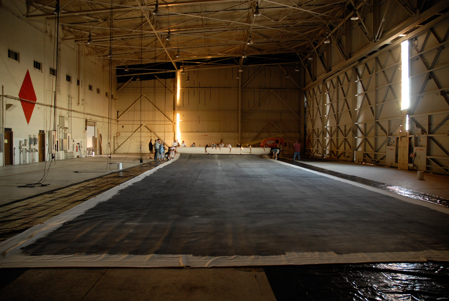 After development and drying, the Great Picture is rolled for transportation and storage onto a custom-made archival spindle.