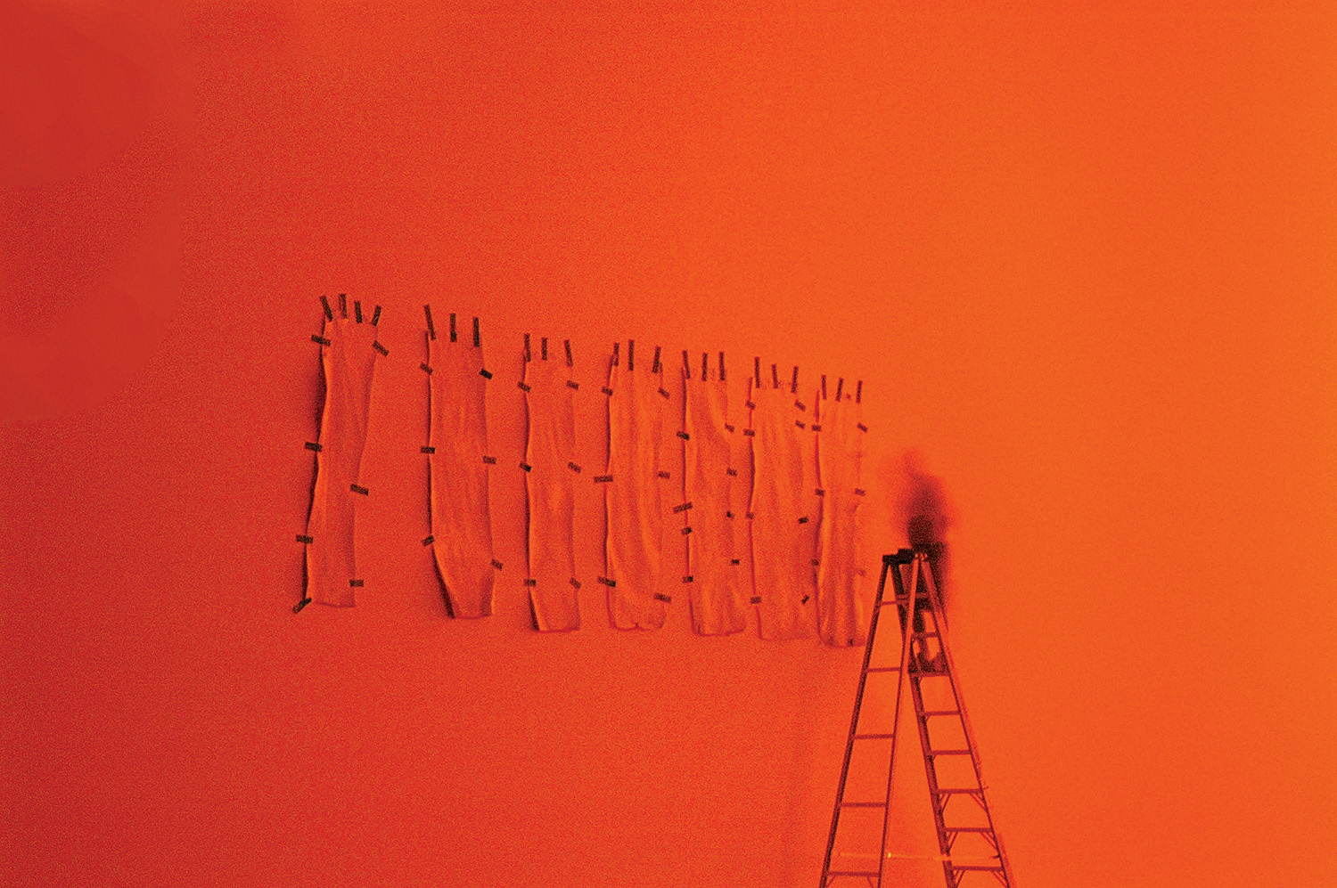 The first row of 8 good test strips hung on the canvas surface from the precarious top of an 14-foot ladder.