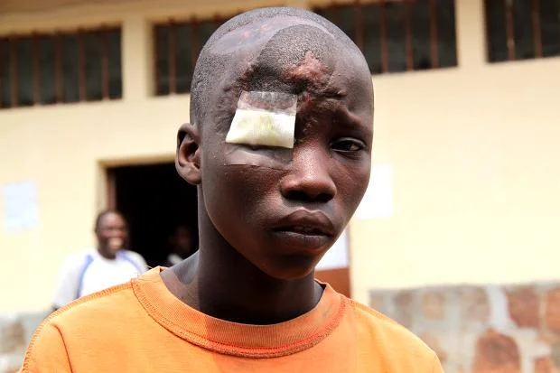 ‘I feel scared in here. I miss my mum and sister,’ says Claude, 13, above, in Mpimba prison