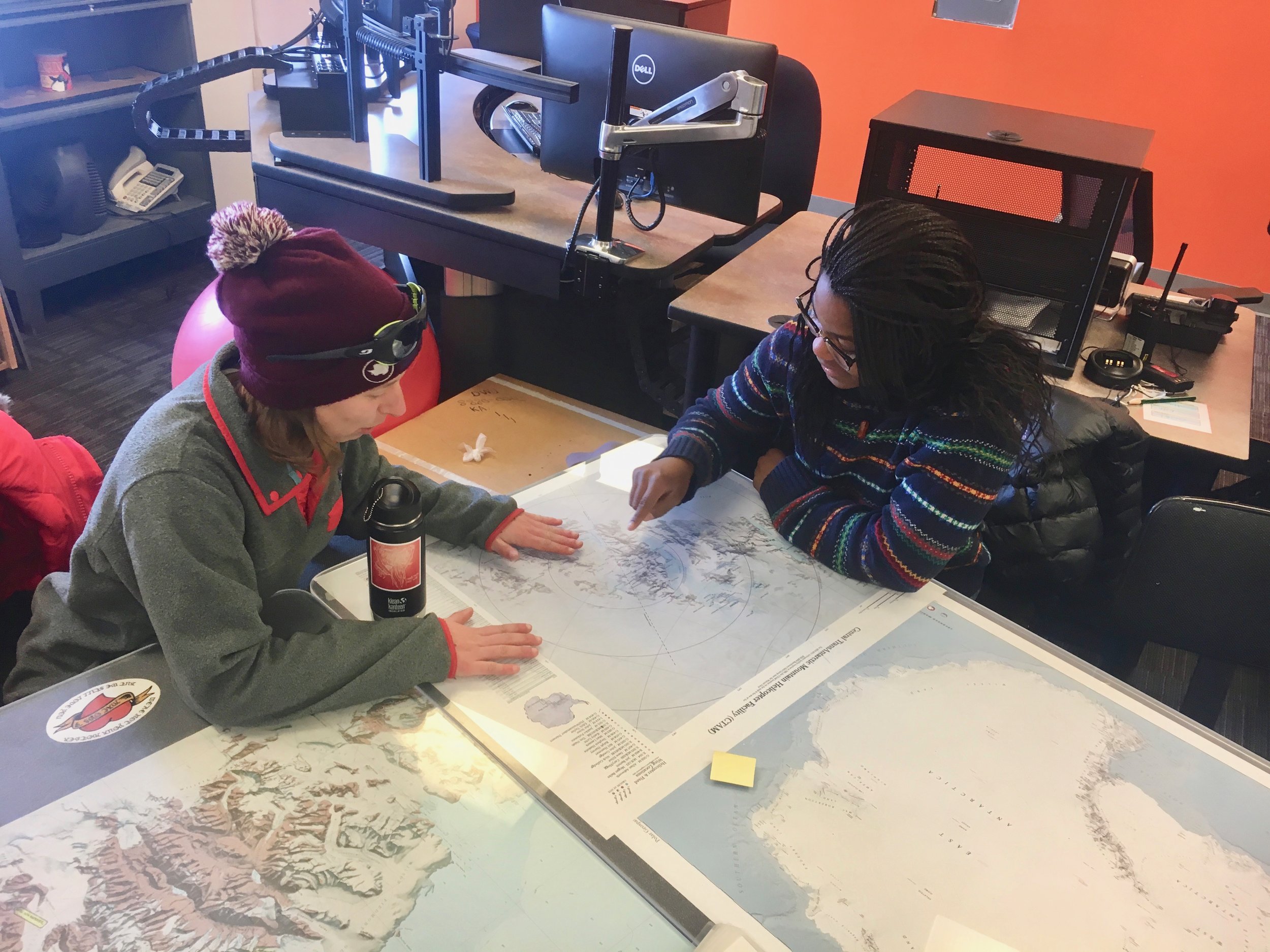 Anny and Emilie scoping the maps before our meeting with "MacOps," the office in charge of communications with groups out in the field.