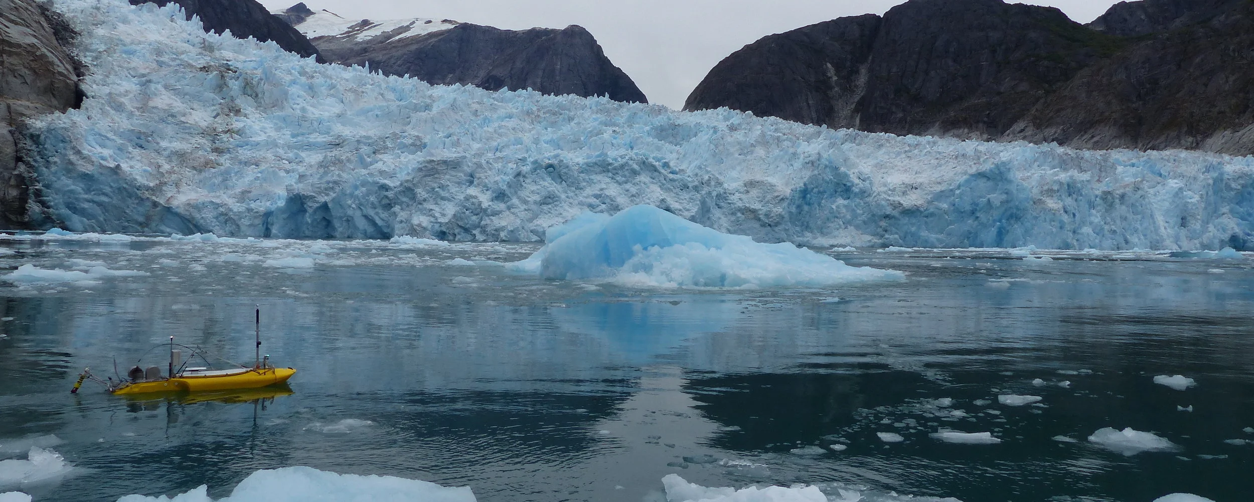 ROSE - the Robotic Oceanographic Surface Explorer - is a remotely-operated science work-horse. ROSE performed 14 missions to the glacier face, during which she collected data deep beneath the ocean surface that reveals (1) how heat flows to the glacier terminus, (2) how melt-water flows away from the terminus, and (3) how the deep ‘subglacial discharge’ rises buoyantly to the surface, simultaneously pulling warm offshore waters into the fjord.