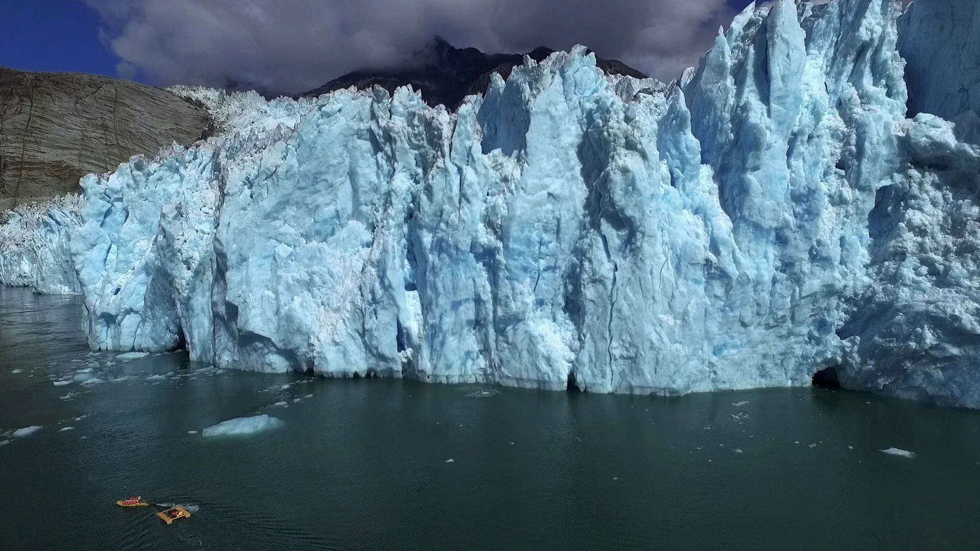 Drone photo of ROSE towing a mooring to the glacier for deployment.