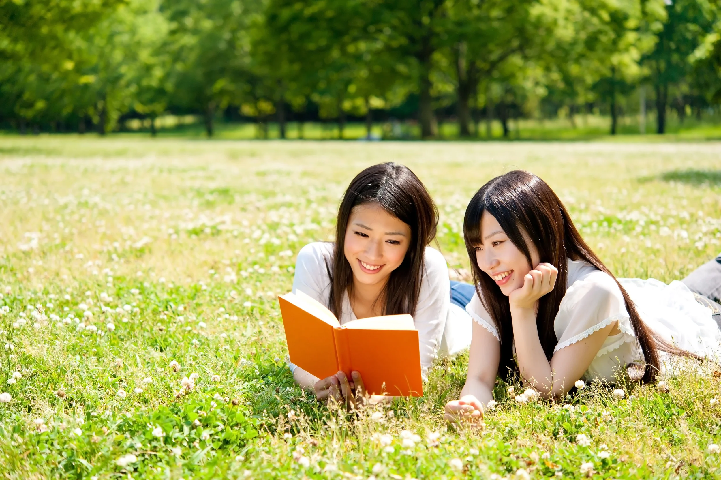 2 girls in a park reading.jpg