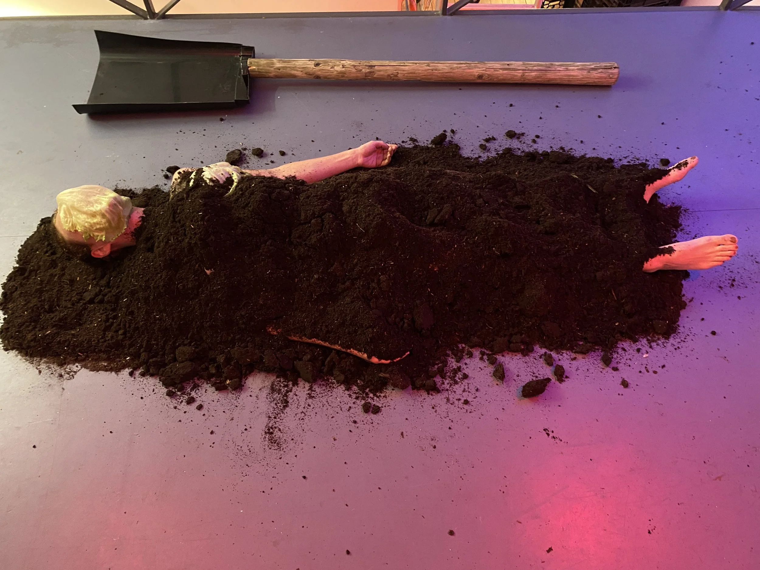   Still from performance ‘Sustainability’,  soil, lettuce, super size spade, PuntWG, 2023, photo credit: Hernan Barrow 