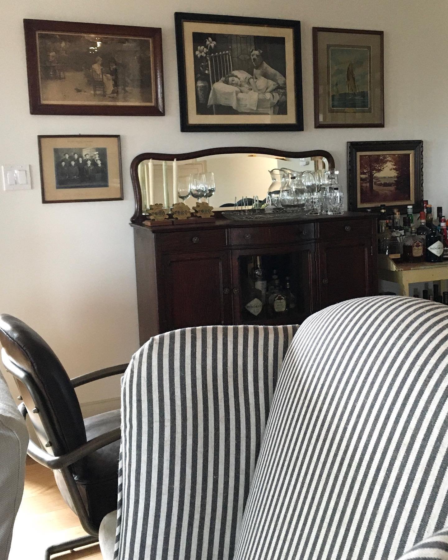 Loading in and unpacking&hellip; // We recovered an old wing chair in this crisp stripe 🤍🖤 and begun hanging a gallery wall of vintage framed pieces over the family&rsquo;s antique sideboard, which is awaiting the addition of a new marble top.  #CR