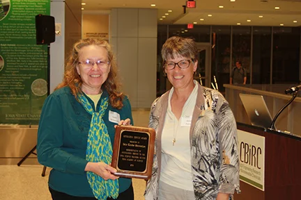 Gale Vermeulen (L) is presented an Outstanding Service Award by Kelen Panec.