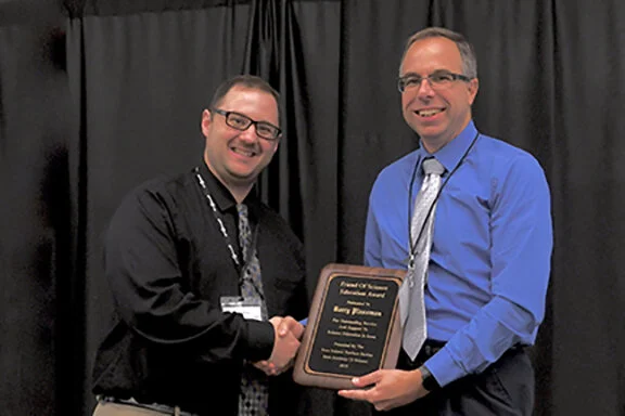 2019 Individual Friend of Science Award was presented to Barry Plassman (R), engineer at John Deer Manufacturing in Waterloo, by Jesse Wilcox, Chair of the Iowa Science Teachers Section