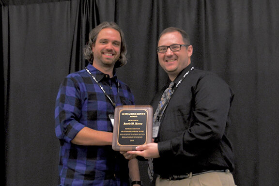 Jerrid Kruse (L), associate professor of science education at Drake University, receives an Outstanding Service Award from Jesse Wilcox, Chair of the Iowa Science Teachers Section.