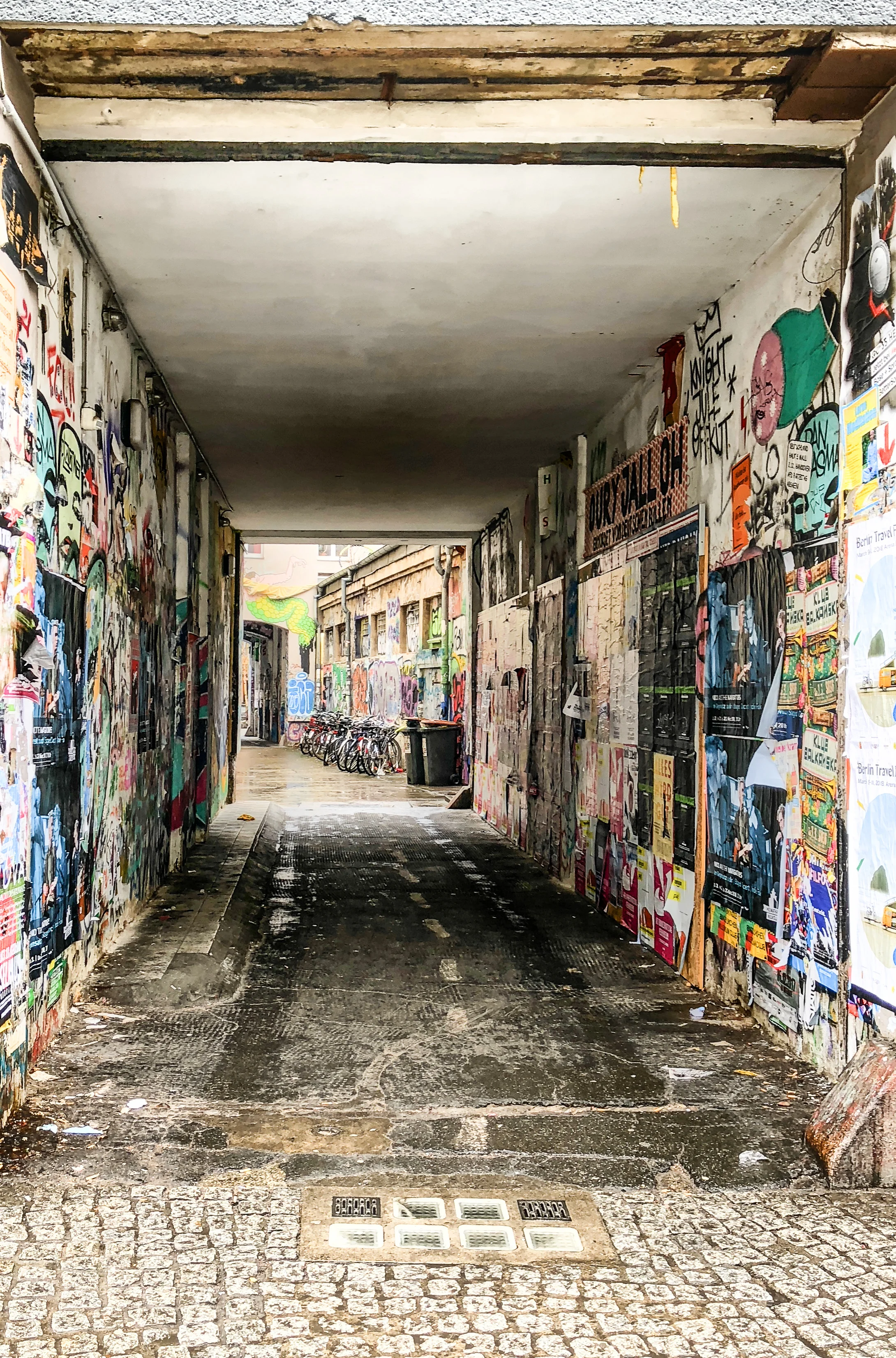 Alleyway with layers of murals and graffiti 