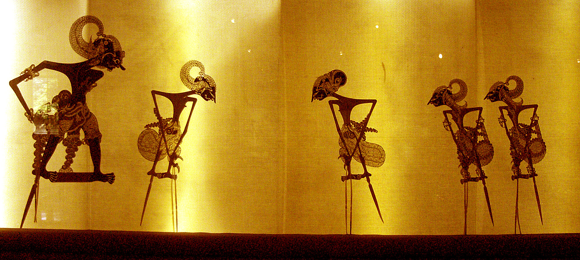 The cover was inspired by a scene in the book where there are shadow puppets which move without anyone controlling them.
