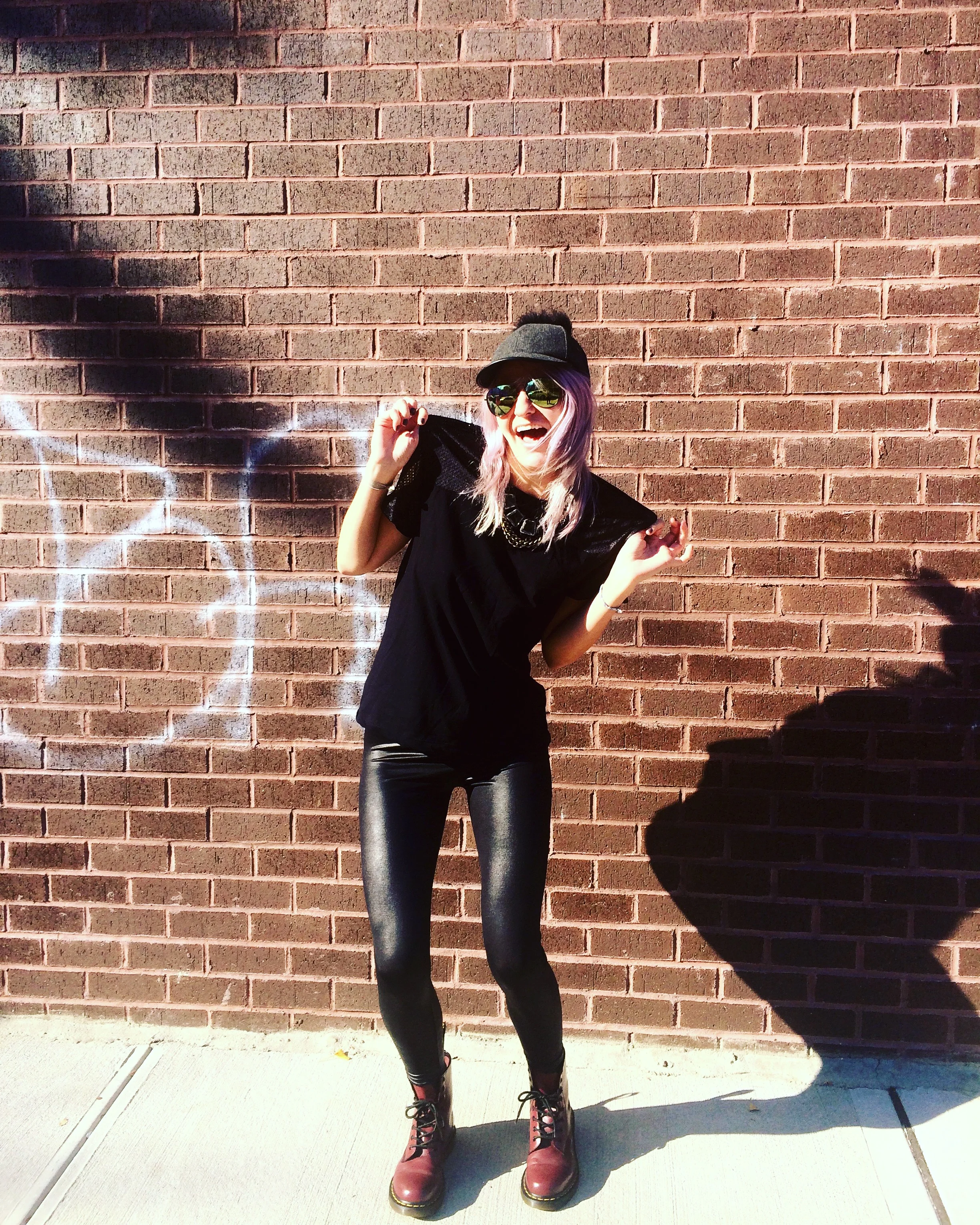 Cap: BCBG, Sunglasses: Nordstrom, Necklace: J.Crew, Mesh Black Tee: American Apparel, Pleather Leggings: HUE, Boots: Doc Marten Location: Bushwick, Brooklyn; Photos by: Victoria Kass