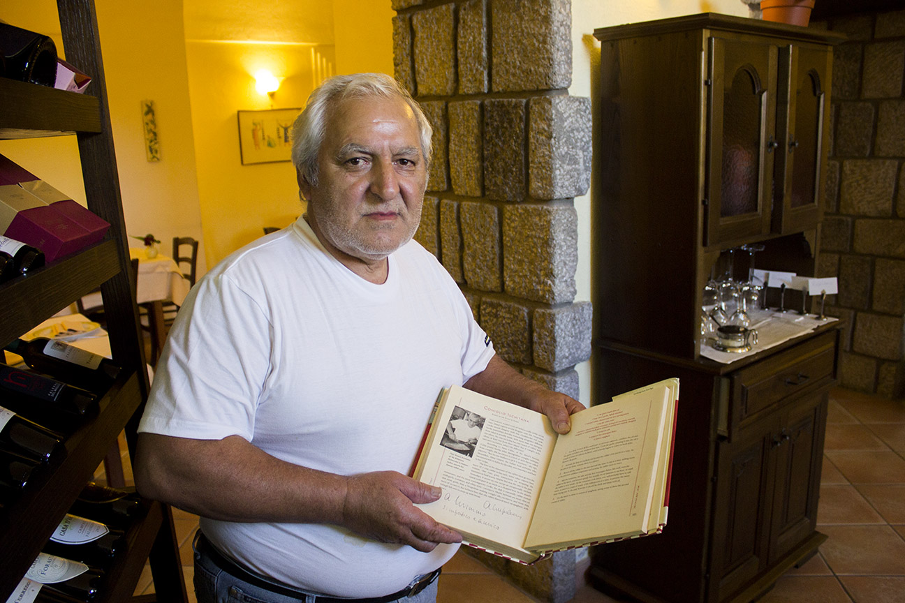 Father showing a article featuring Ristorante Il Borghetto