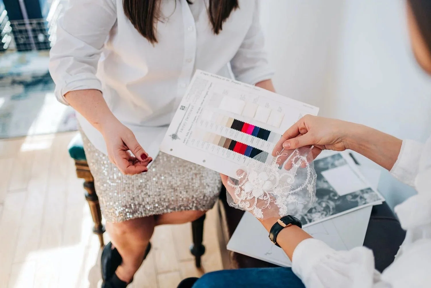 Sarah Foy discussing fabric options with bride