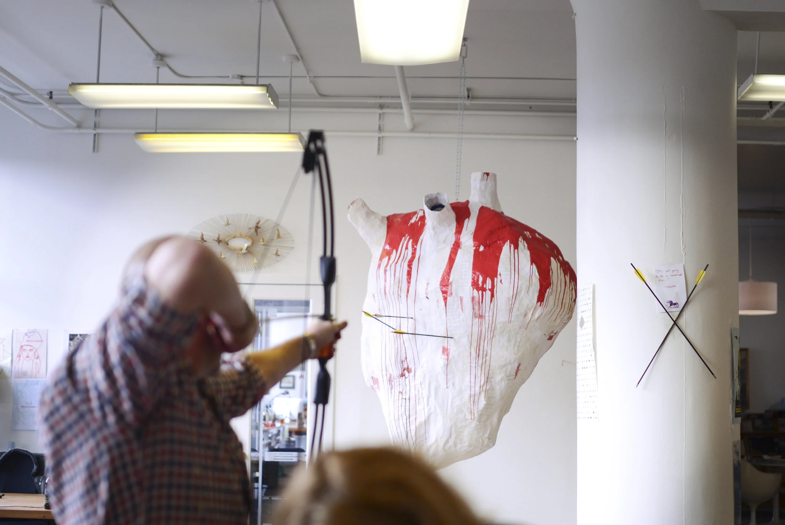 I created a giant paper mache heart made out of old agency decks in the recycling bin. I then hid blood packets in the heart.  