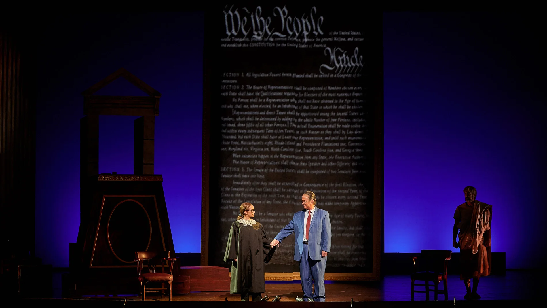 “We are different. We are one”: the 2019 OperaDelaware production of  Scalia/Ginsburg . L to R: Jennifer Zetlan (Justice Ginsburg), Brian Cheney (Justice Scalia), Ben Wager (The Commentator). Photo: Justin Heyes, Moonloop Photography.