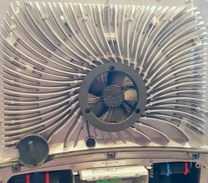 The new generation Fronius Symo hybrid solar inverter with the front cover removed, revealing the advanced spiral heat sink design.