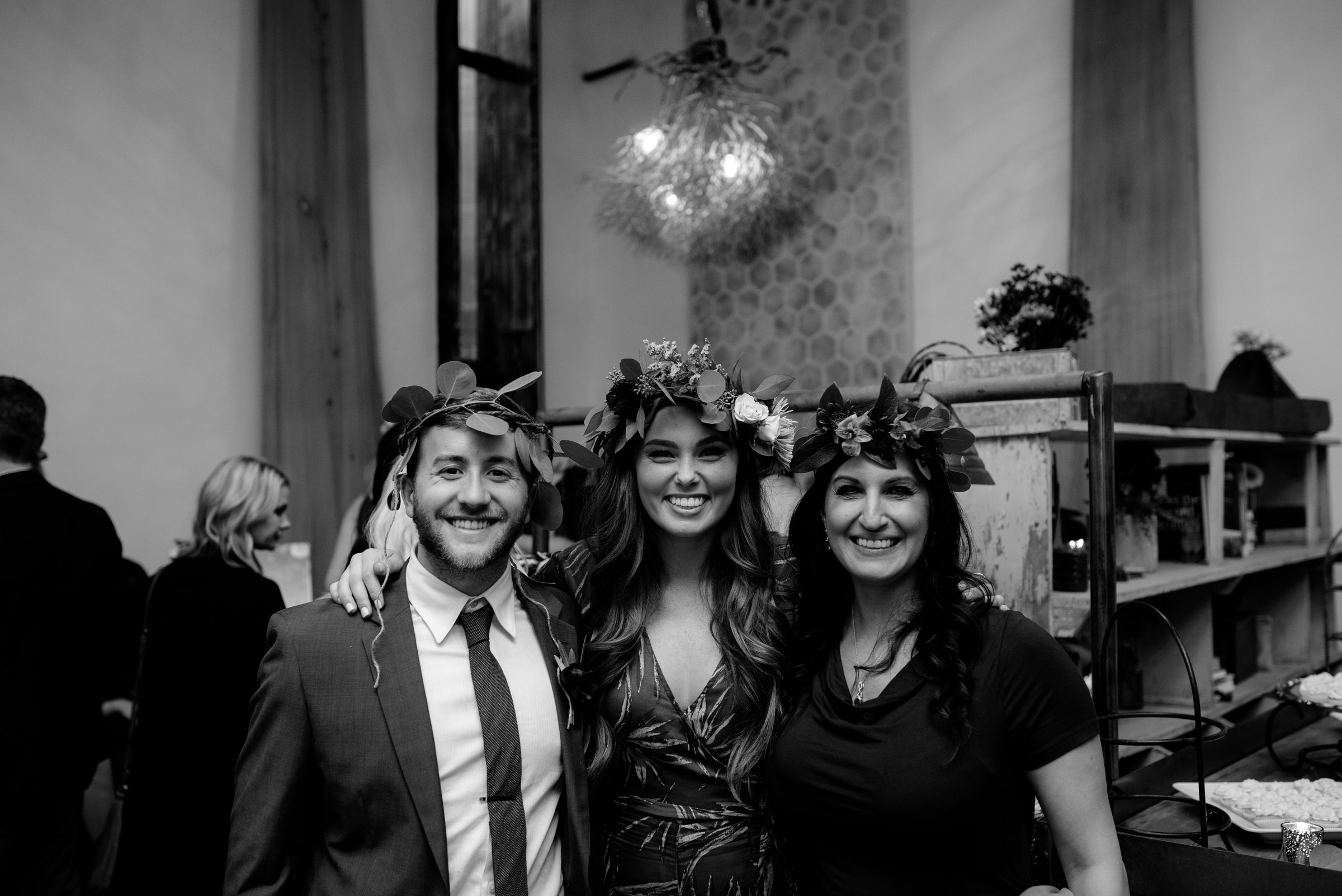  guests posing wearing flower crowns wedding vuka collective austin texas 