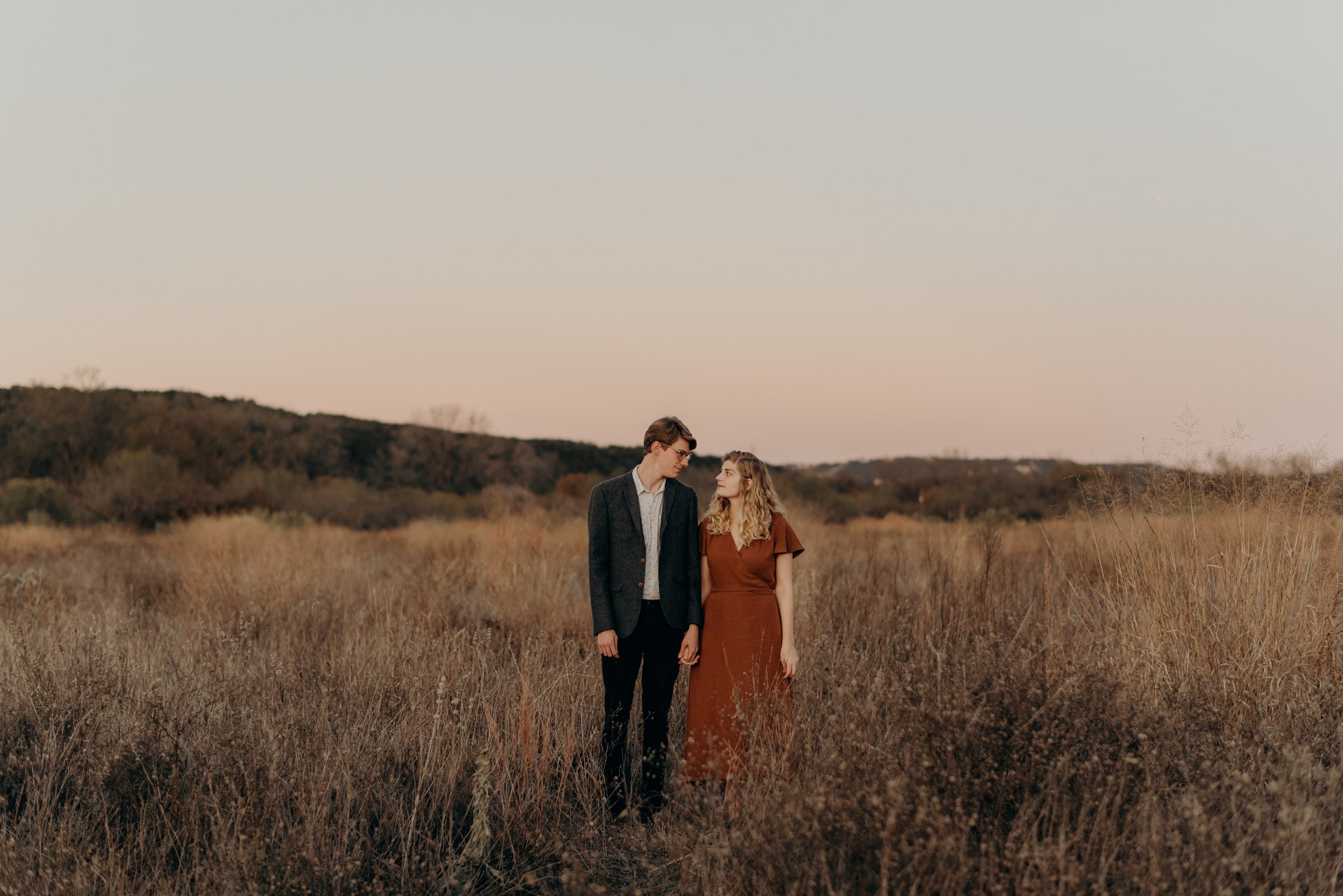  golden hour sunset portraits couple in field commons ford ranch park austin texas engagement session 