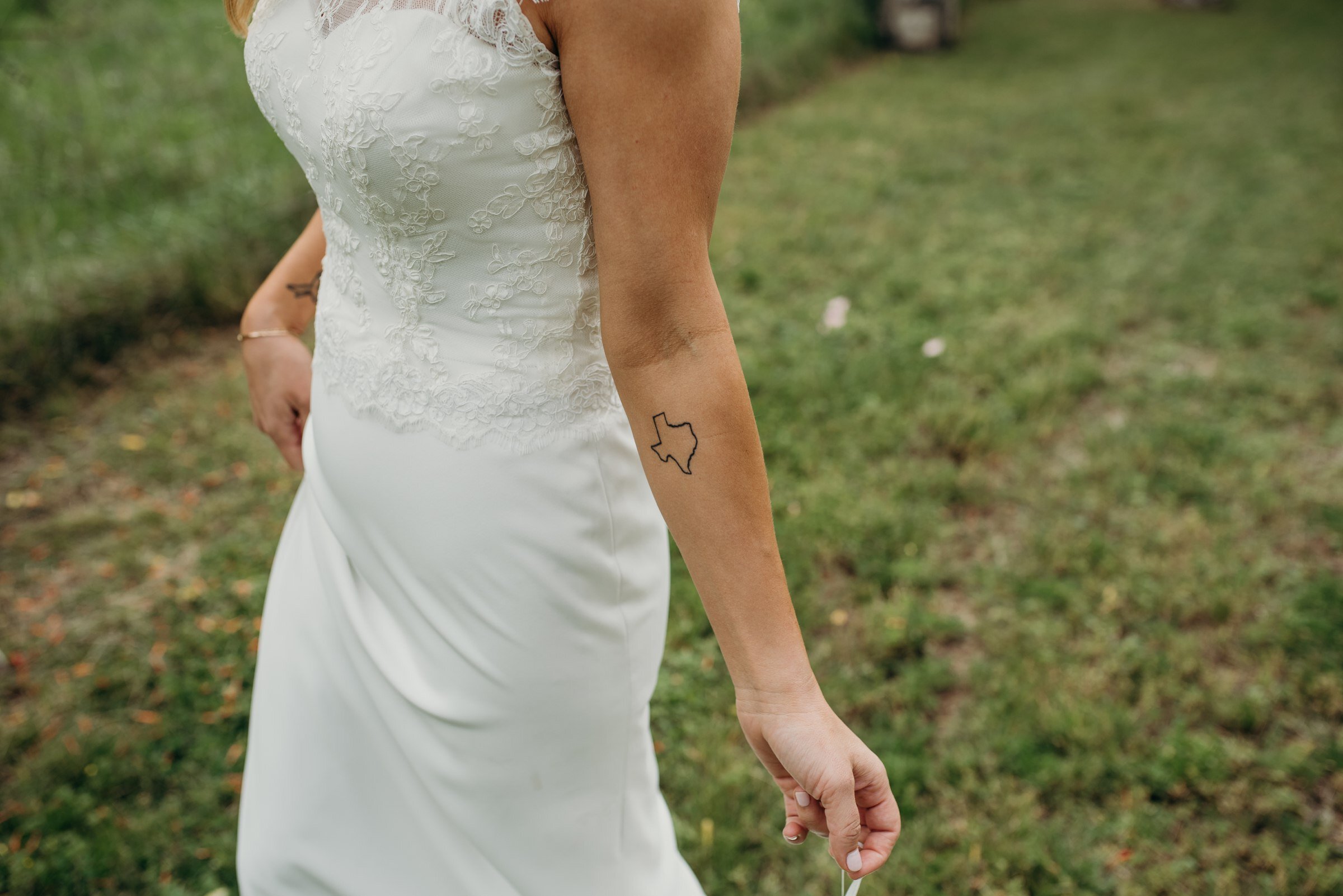  texas state tattoo on arm of bride plant at kyle wedding venue austin texas 