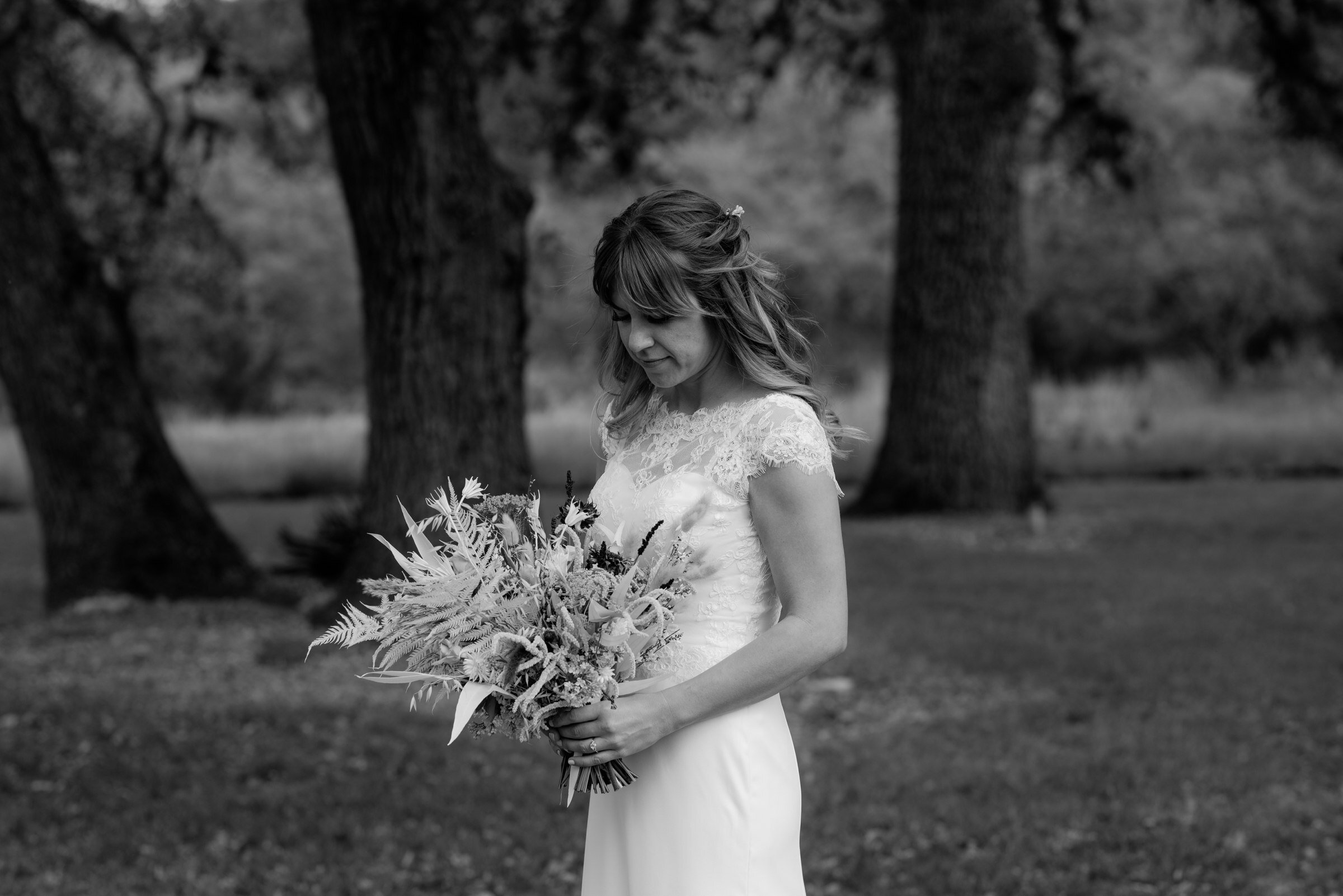  portrait of bride holding bouquet at plant at kyle wedding venue austin texas 