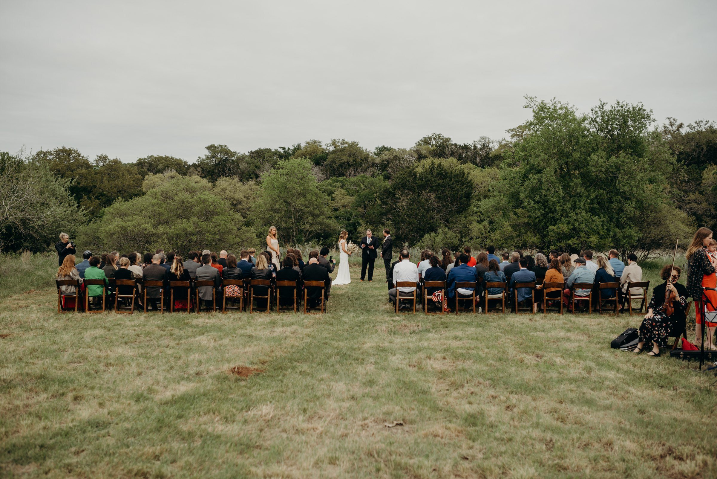  wedding ceremony in field plant at kyle wedding venue austin texas 
