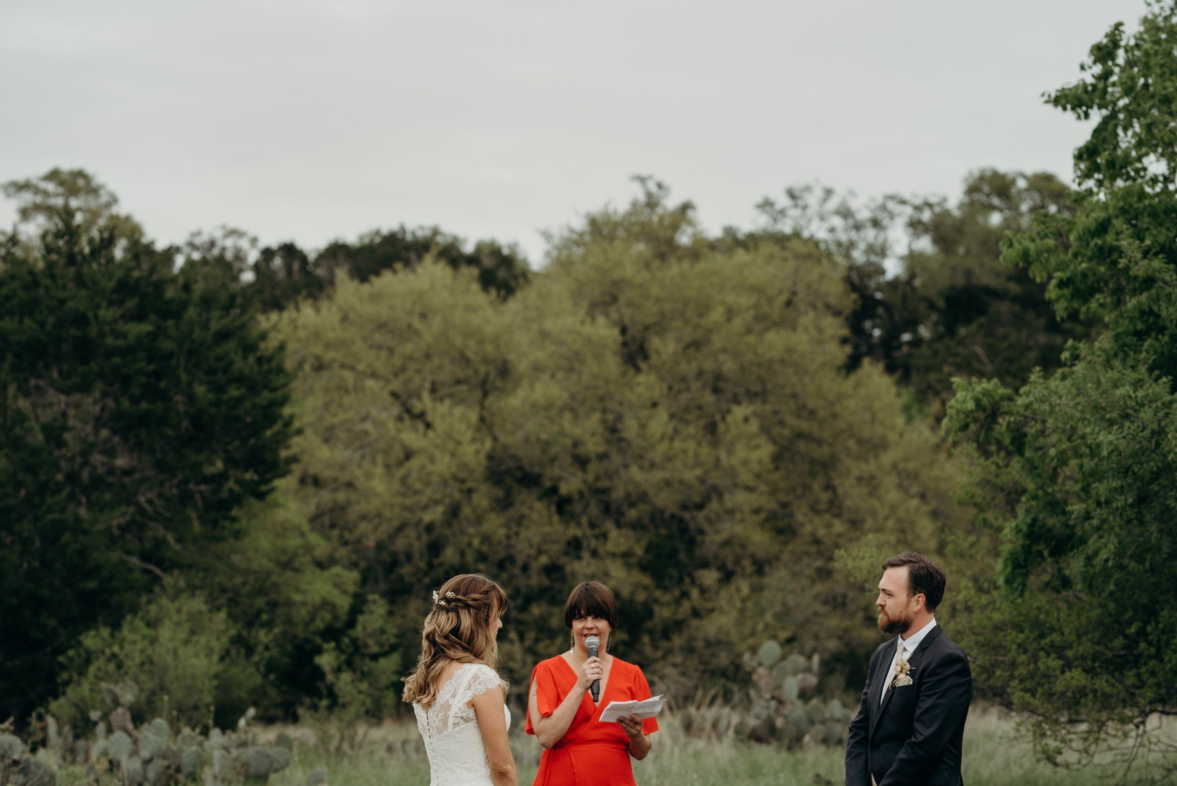  wedding ceremony in field plant at kyle wedding venue austin texas 