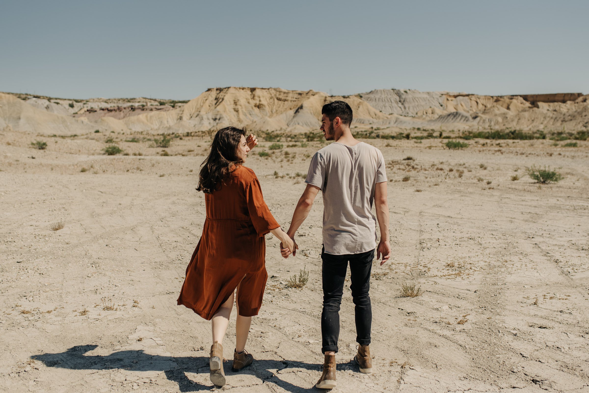  couple walking in desert in terlingua west texas during big bend couples session 