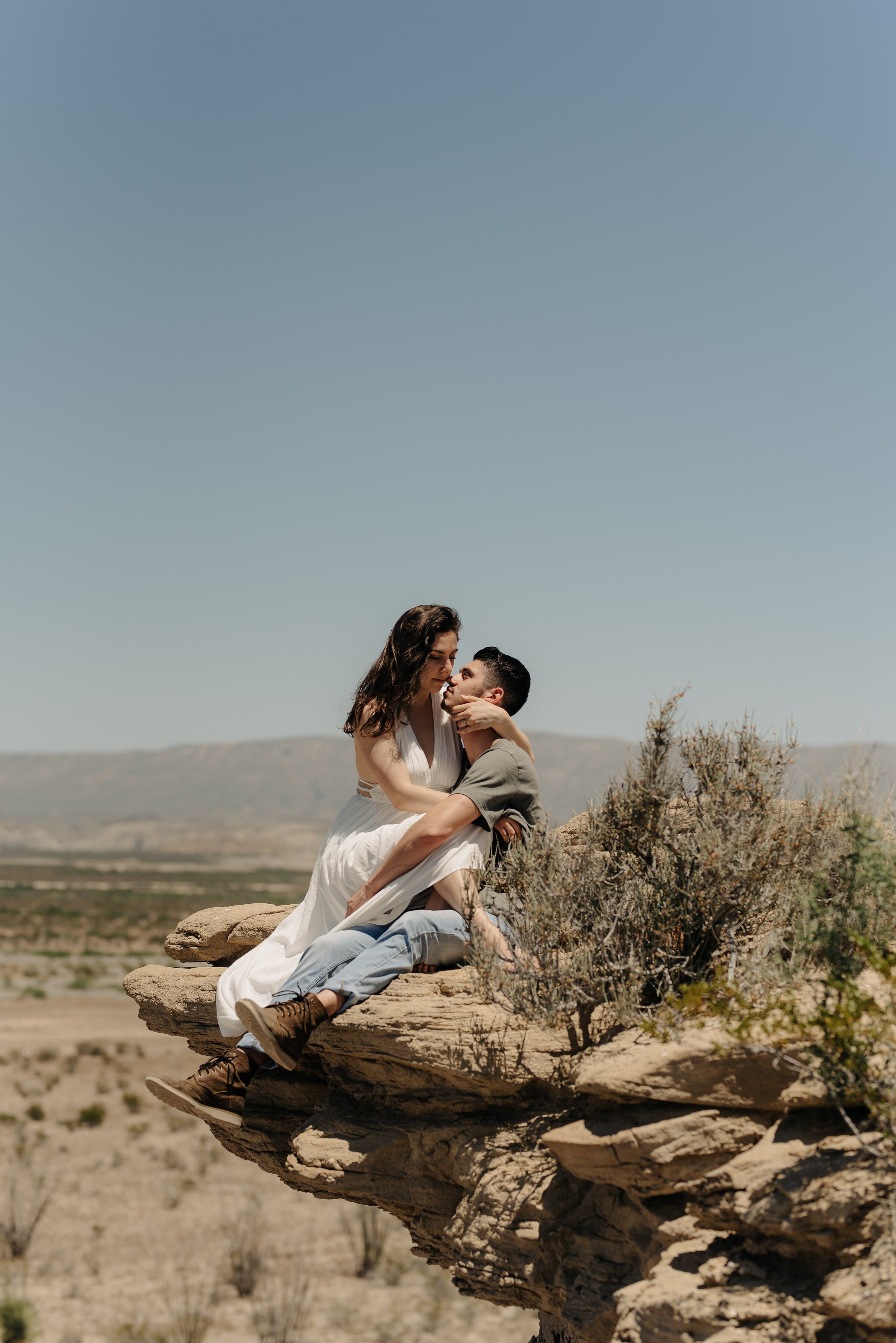  couple sitting on top of rock big bend national park engagement session 